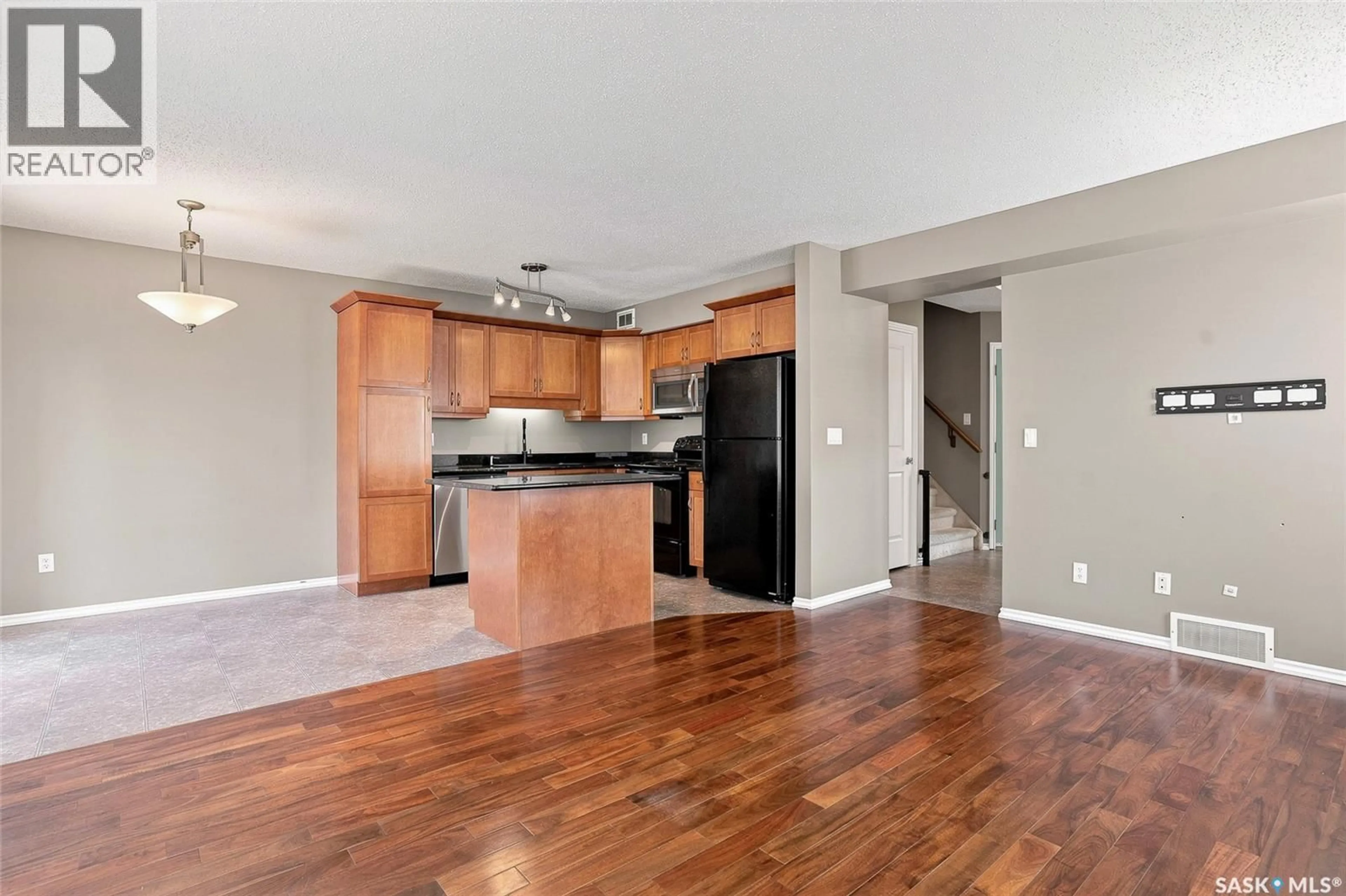 Open concept kitchen, wood/laminate floor for 105 - 201 LYND CRESCENT, Saskatoon Saskatchewan S7T0C3