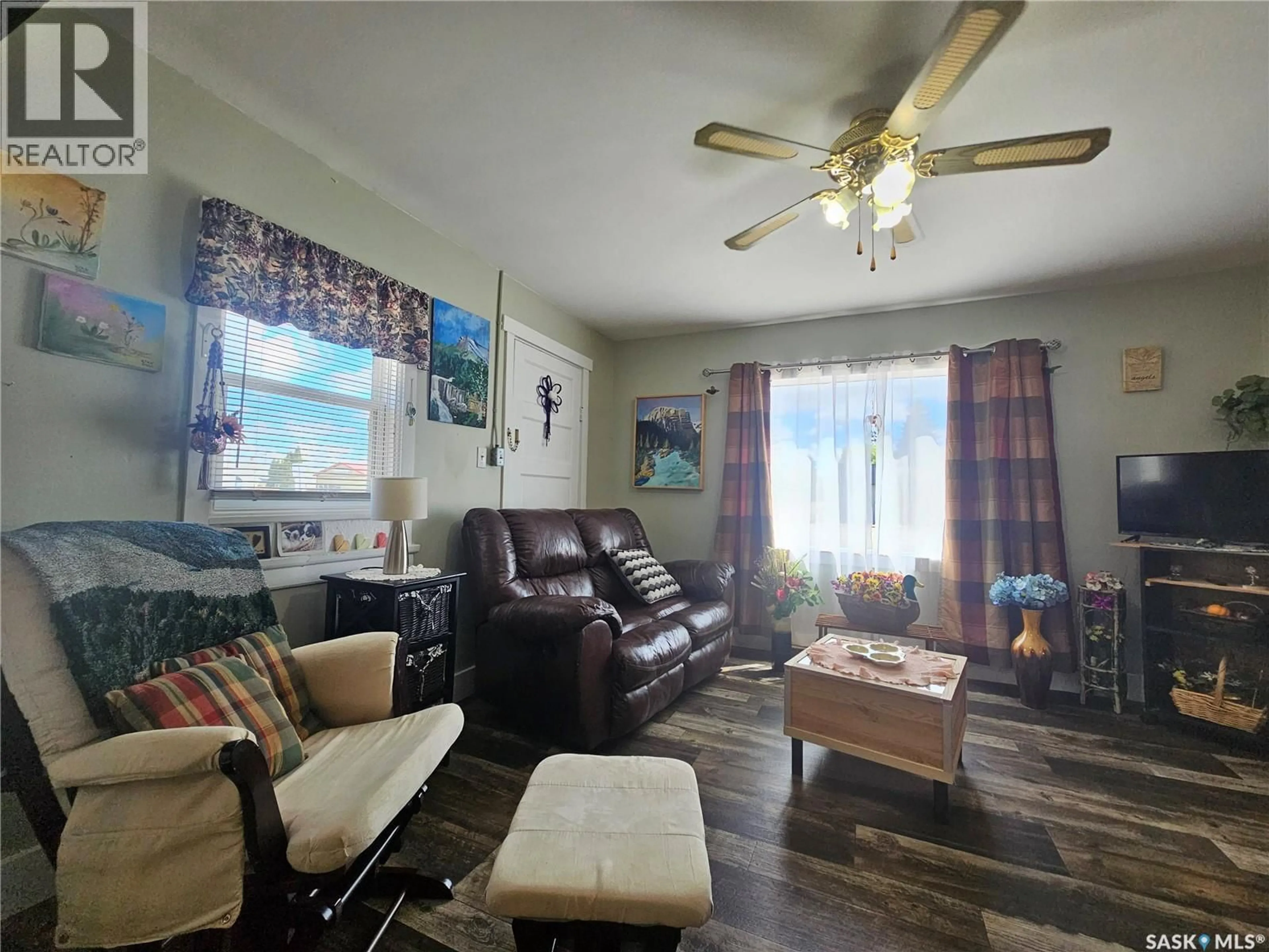 Living room with furniture, wood/laminate floor for 201 MAIN STREET, Glaslyn Saskatchewan S0M0Y0
