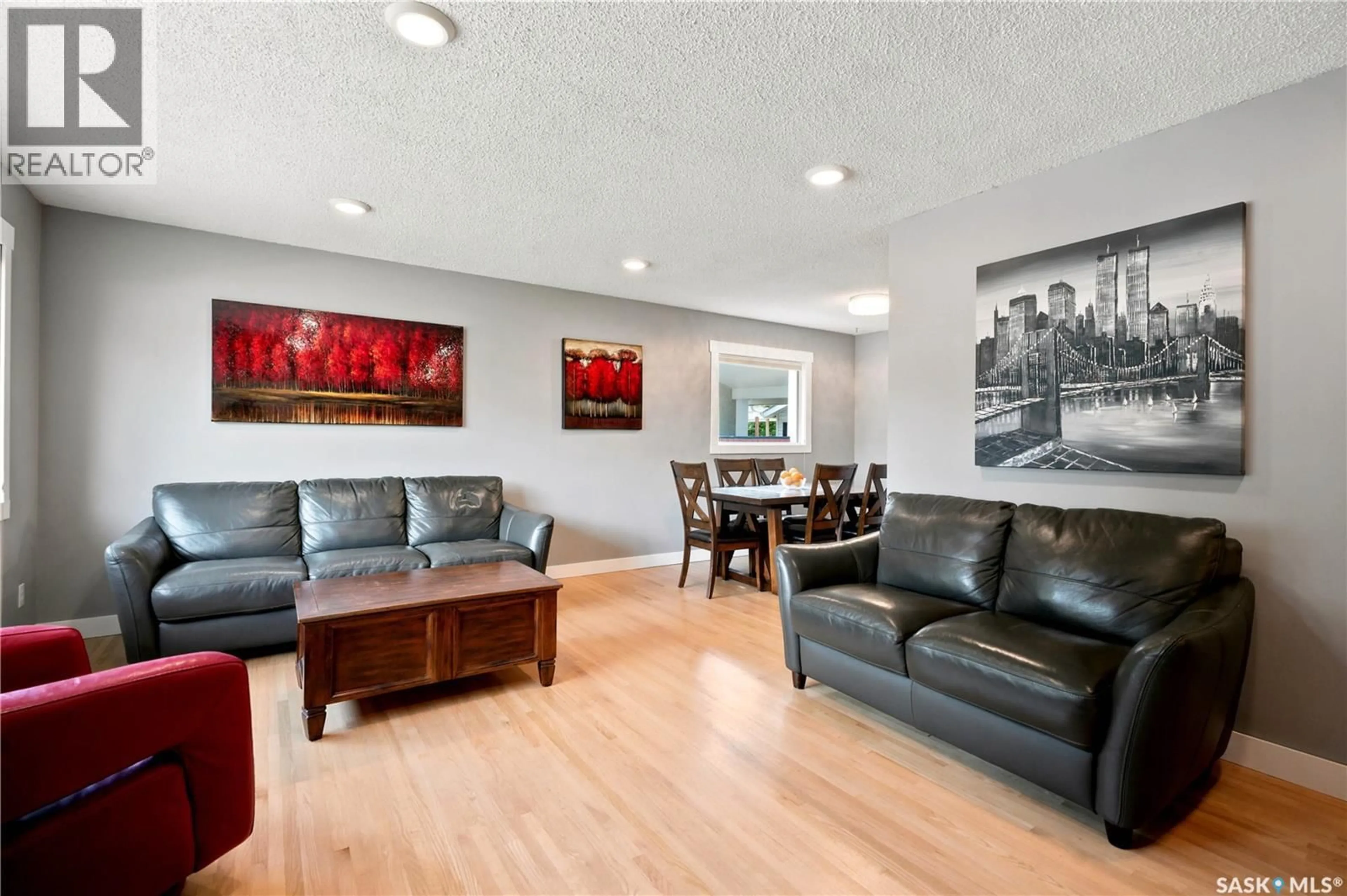 Living room with furniture, wood/laminate floor for 52 TUCKER CRESCENT, Saskatoon Saskatchewan S7H3H5