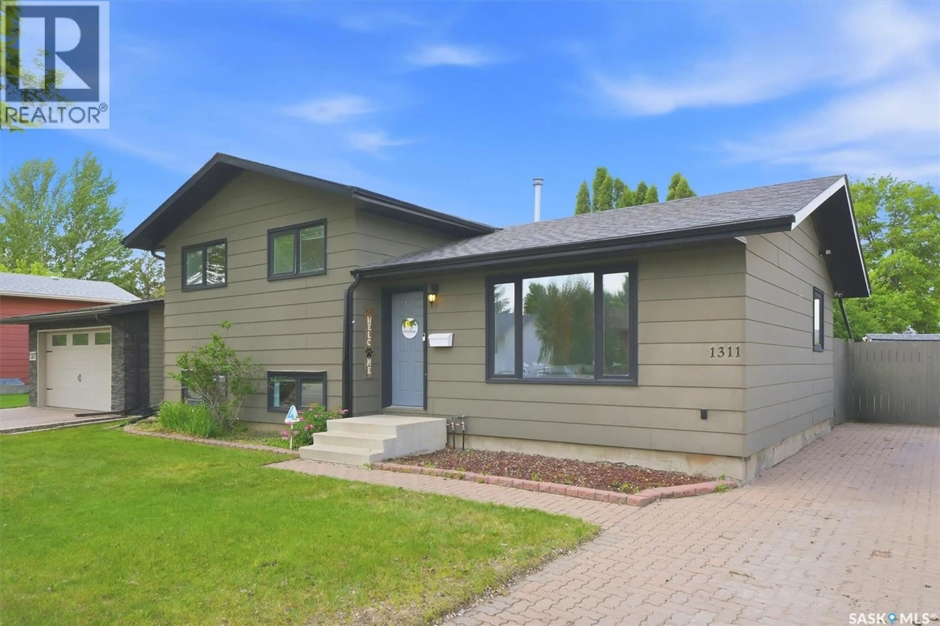 Home with vinyl exterior material, street for 1311 LATRACE ROAD, Saskatoon Saskatchewan S7L6E4