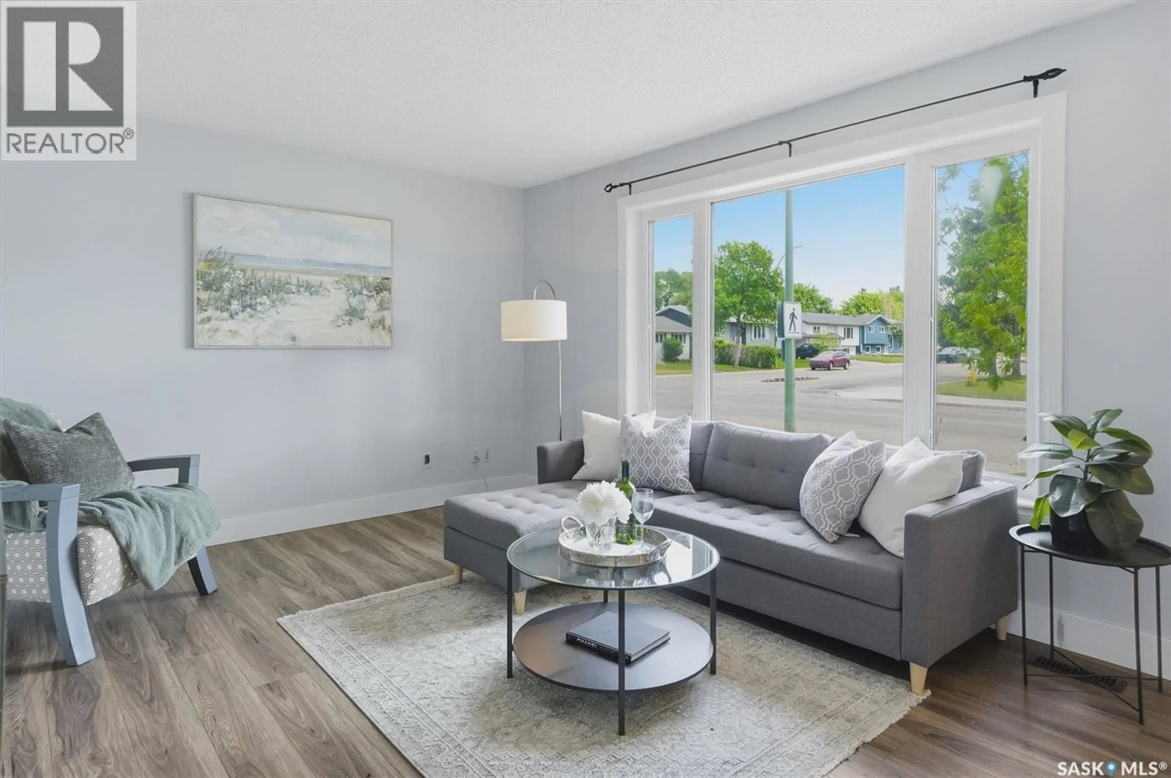 Living room with furniture, wood/laminate floor for 1311 LATRACE ROAD, Saskatoon Saskatchewan S7L6E4