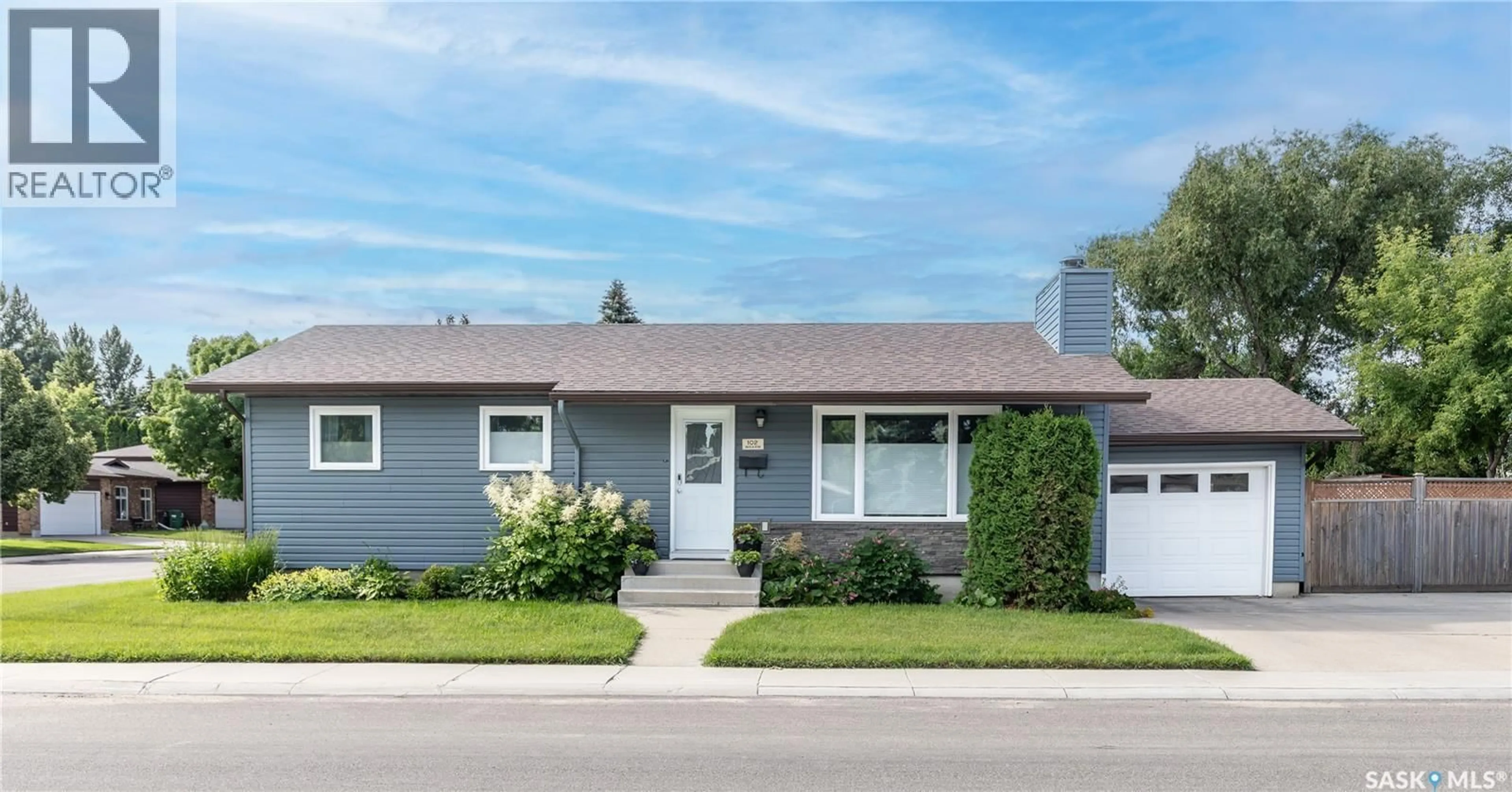 Home with vinyl exterior material, street for 102 WAKAW CRESCENT, Saskatoon Saskatchewan S7J4E2