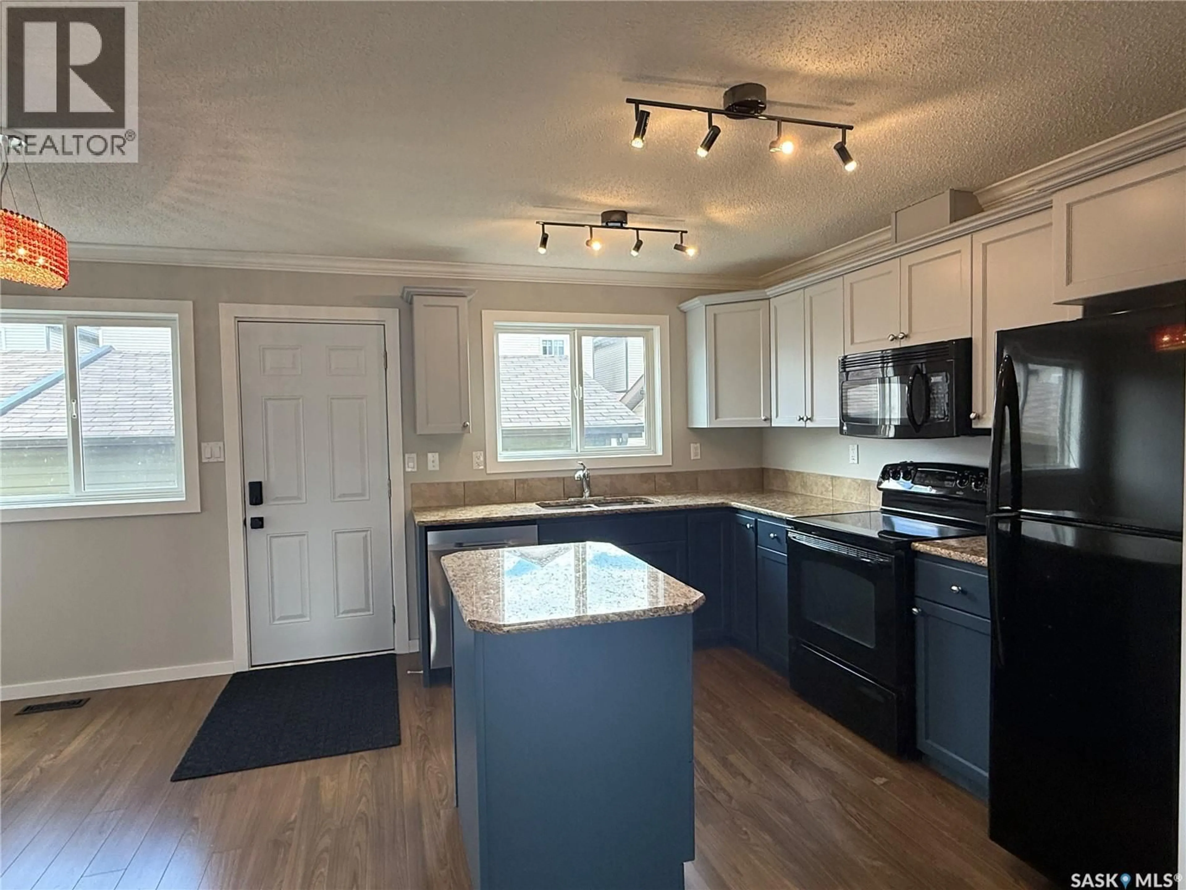 Open concept kitchen, wood/laminate floor for 307 - 810 HAMPTON CIRCLE, Saskatoon Saskatchewan S7R0K2