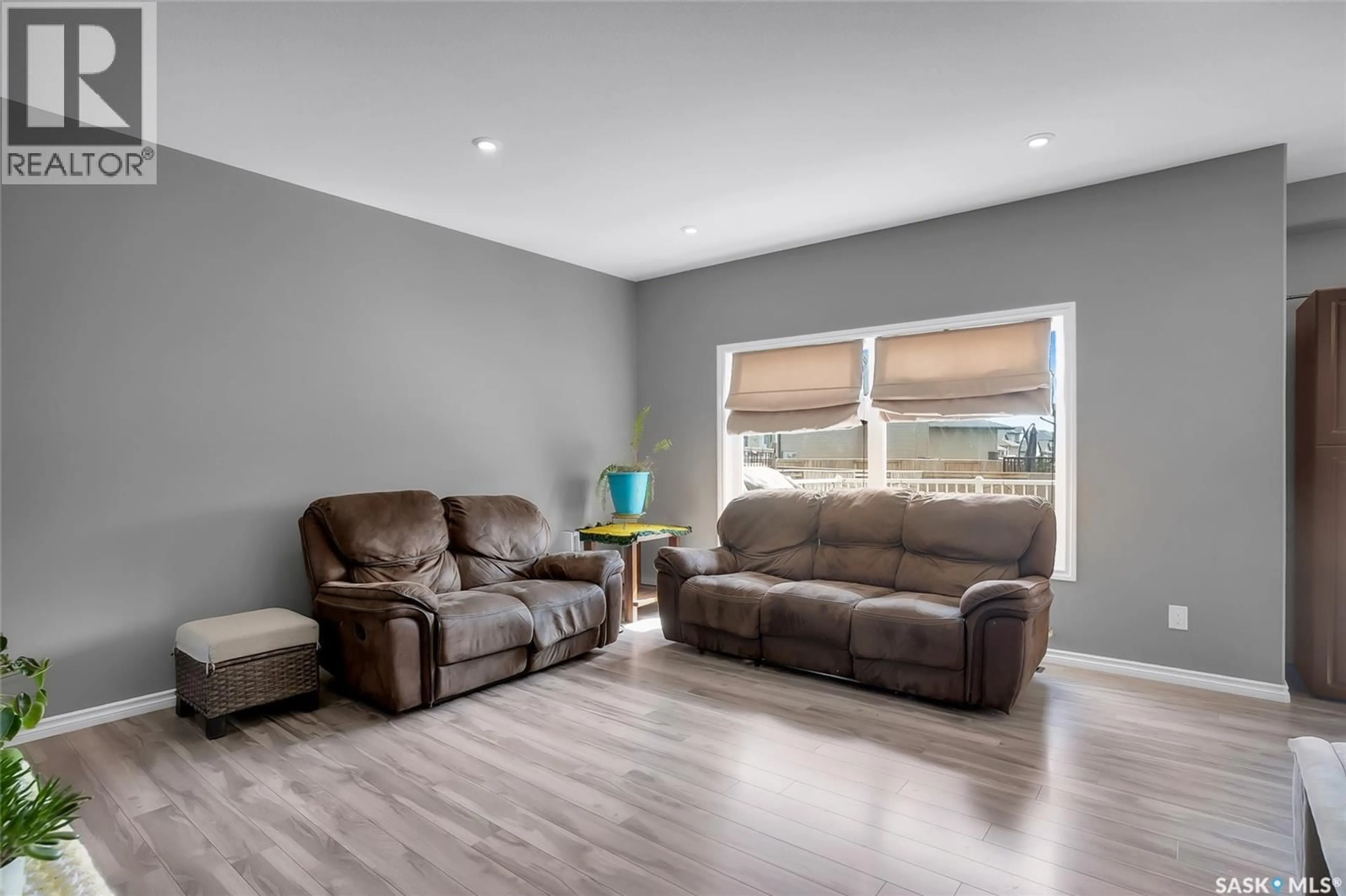 Living room with furniture, wood/laminate floor for 222 PRINGLE LANE, Saskatoon Saskatchewan S7T0S3