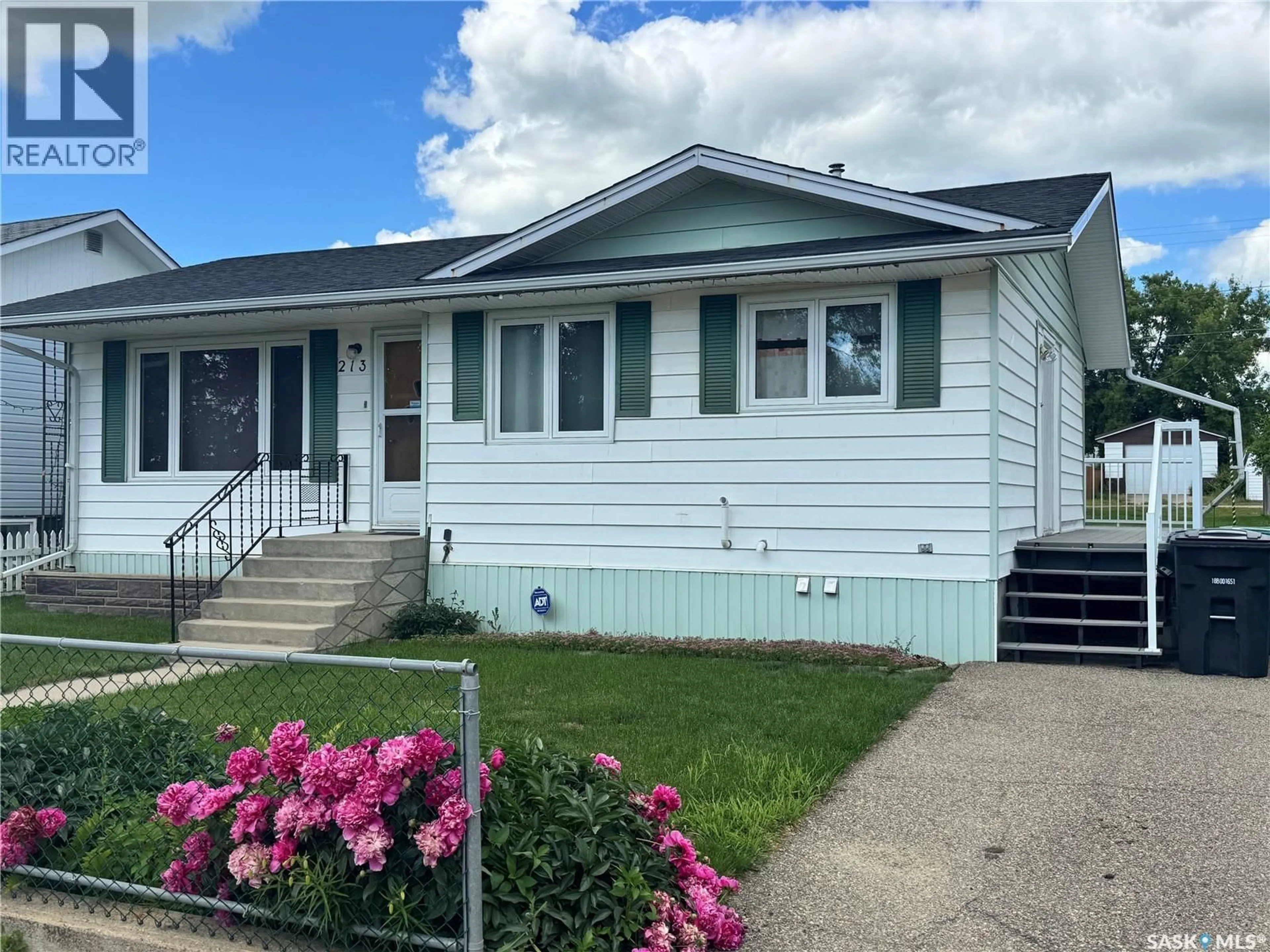 Home with vinyl exterior material, street for 213 5TH AVENUE, Biggar Saskatchewan S0K0M0