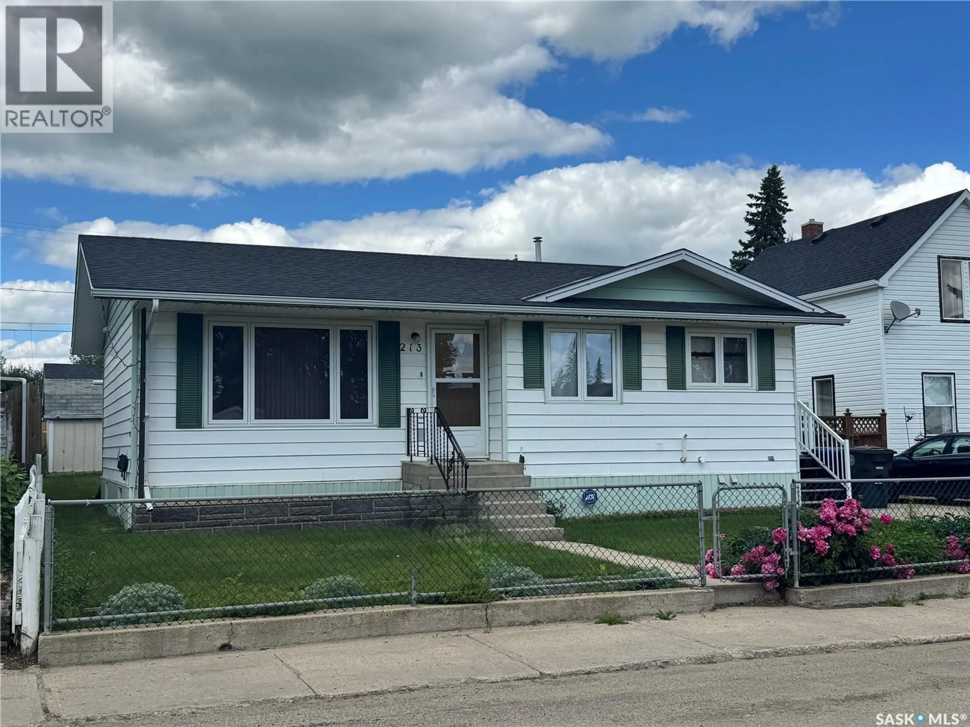 Home with vinyl exterior material, street for 213 5TH AVENUE, Biggar Saskatchewan S0K0M0