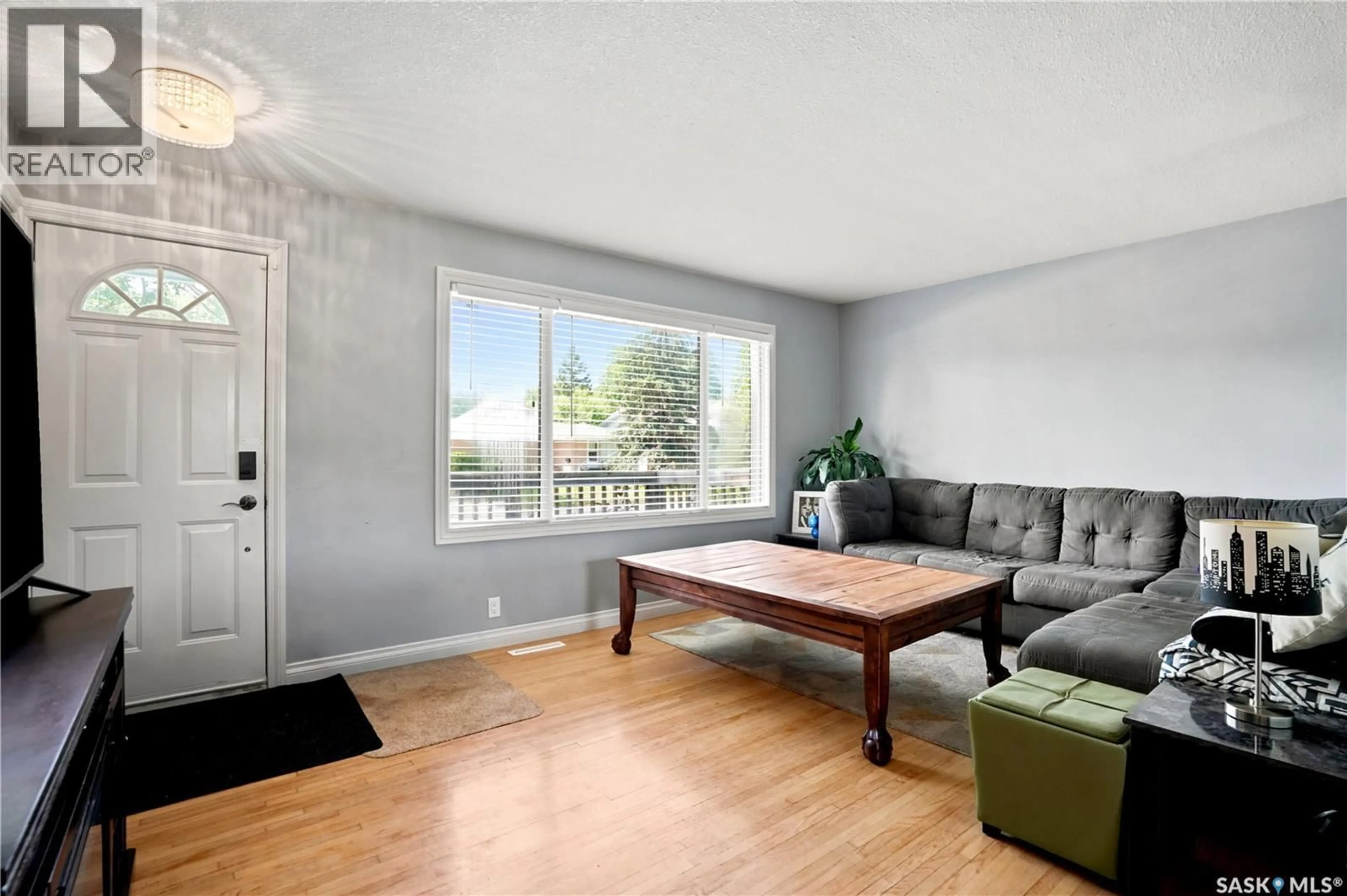 Living room with furniture, wood/laminate floor for 813 HORACE STREET, Regina Saskatchewan S4T5K9