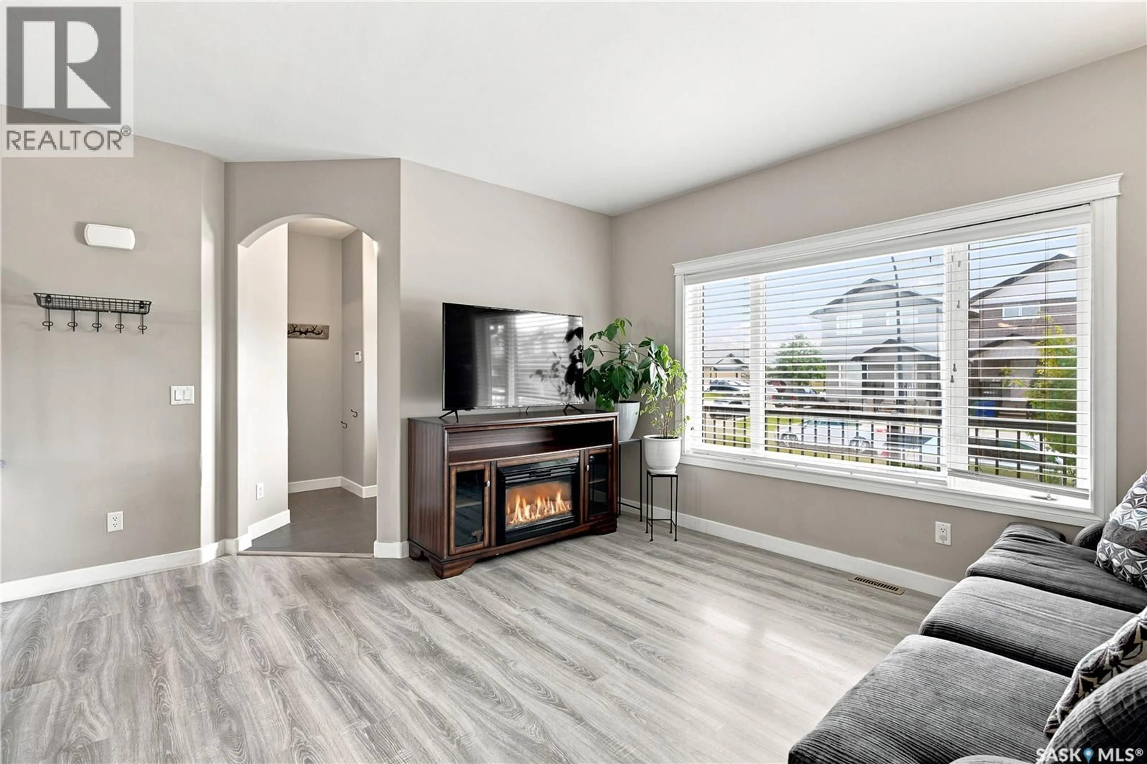 Living room with furniture, wood/laminate floor for 835 LAMARSH LANE, Saskatoon Saskatchewan S7W1B7