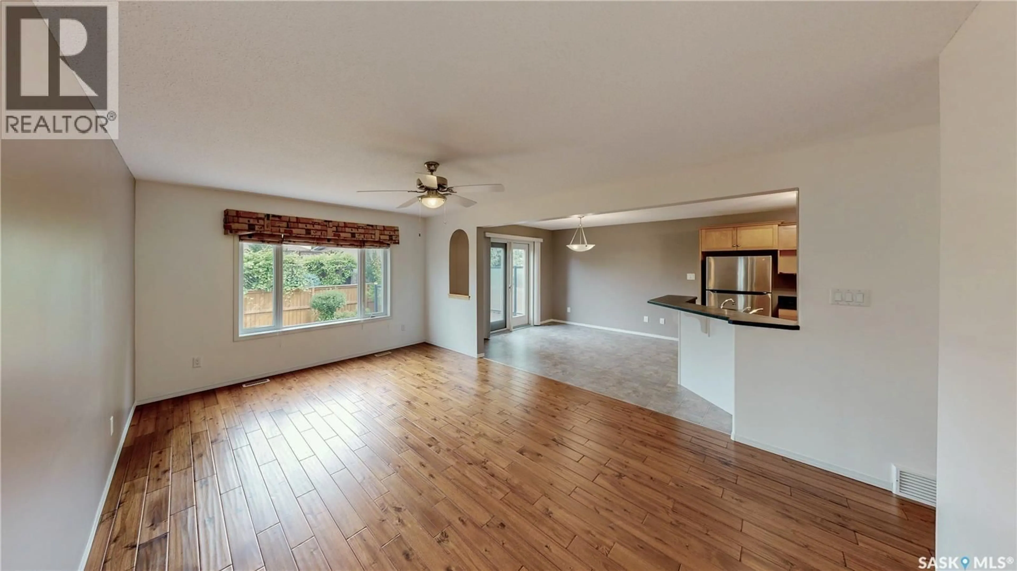 Open concept kitchen, wood/laminate floor for 7058 WASCANA COVE DRIVE, Regina Saskatchewan S4V3E9