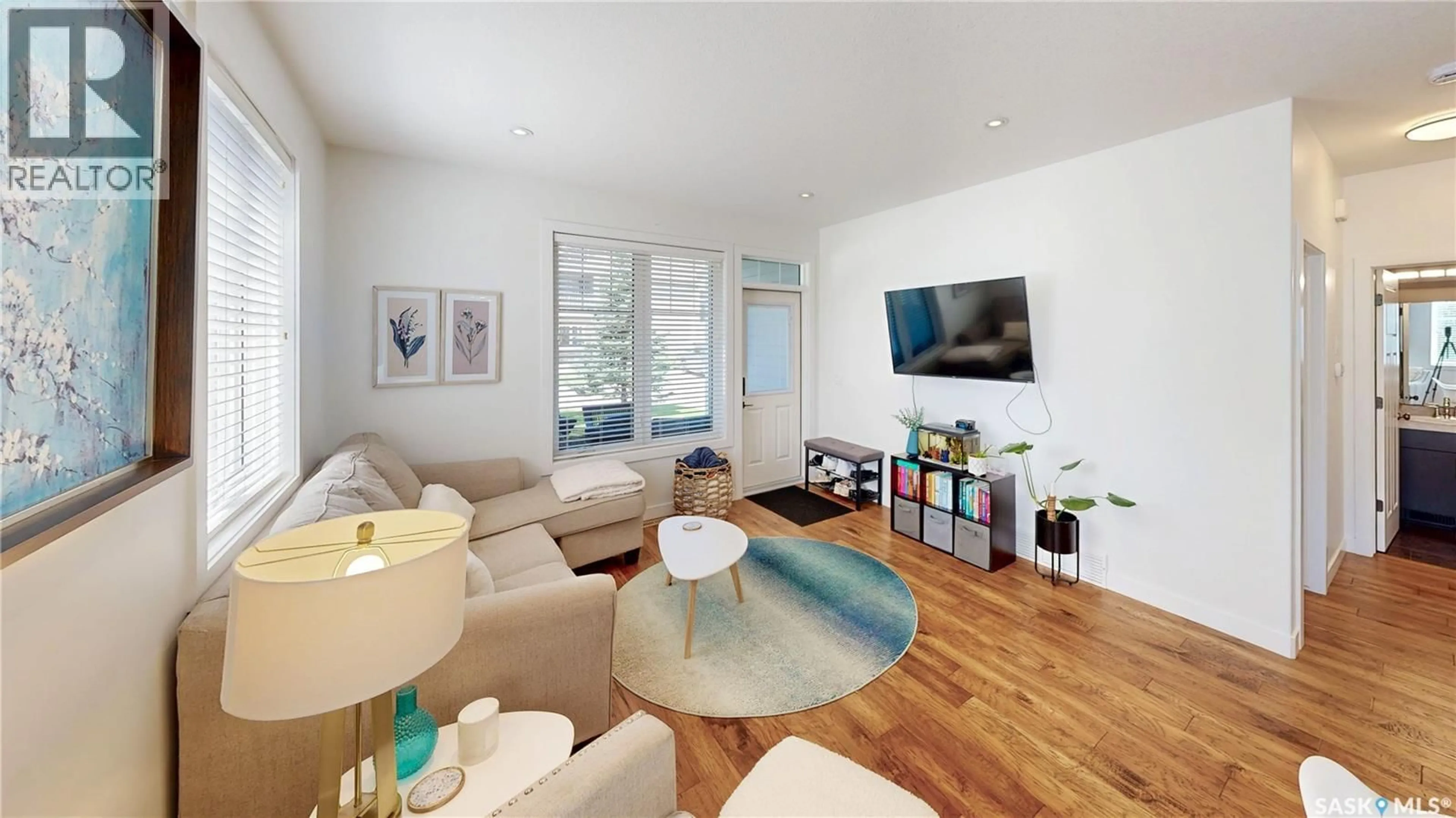 Living room with furniture, wood/laminate floor for 4241 GREEN APPLE DRIVE, Regina Saskatchewan S4V1S1