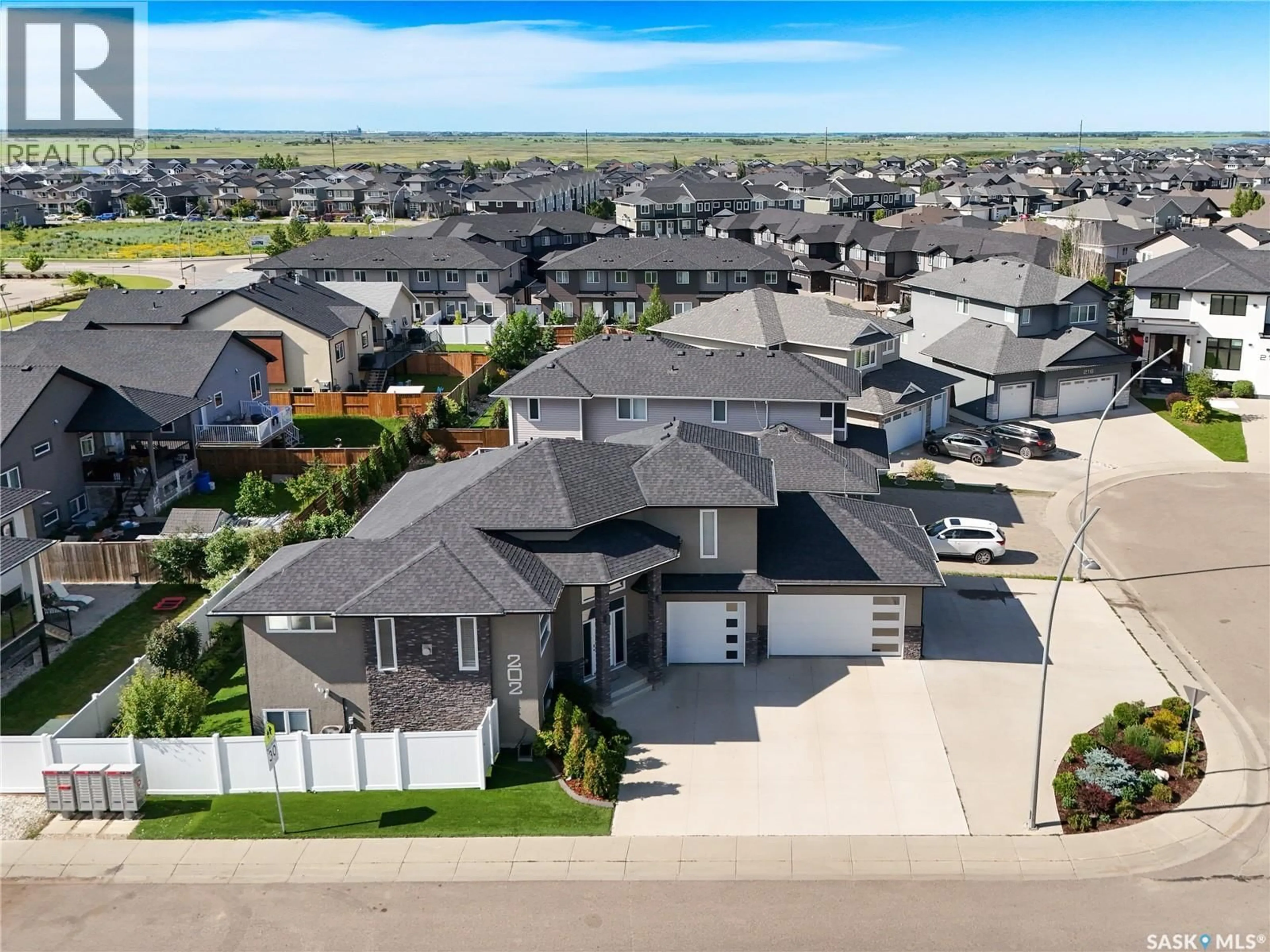 A pic from outside/outdoor area/front of a property/back of a property/a pic from drone, street for 202 GLACIAL SHORES COVE, Saskatoon Saskatchewan S7W0R7