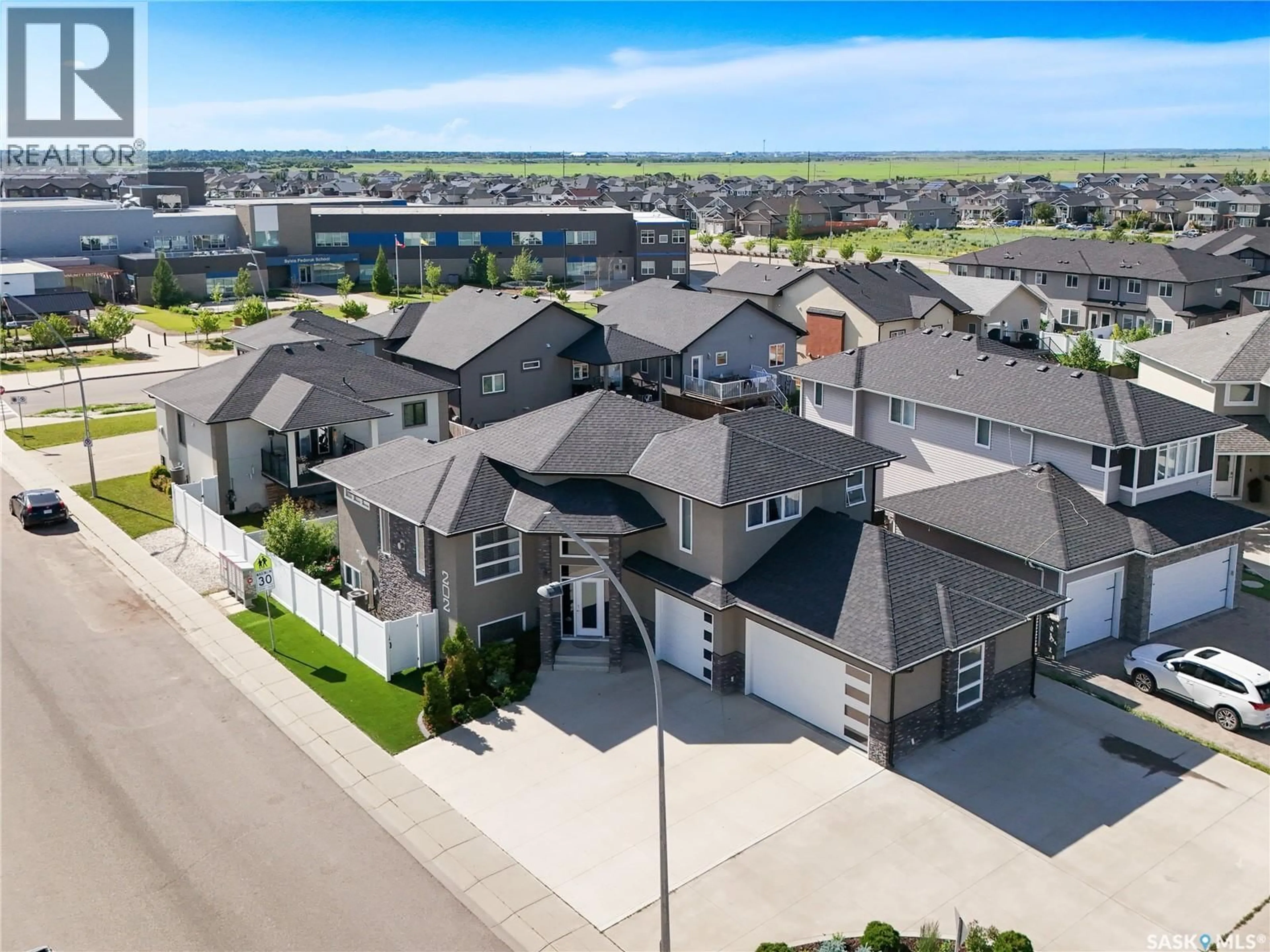 A pic from outside/outdoor area/front of a property/back of a property/a pic from drone, street for 202 GLACIAL SHORES COVE, Saskatoon Saskatchewan S7W0R7