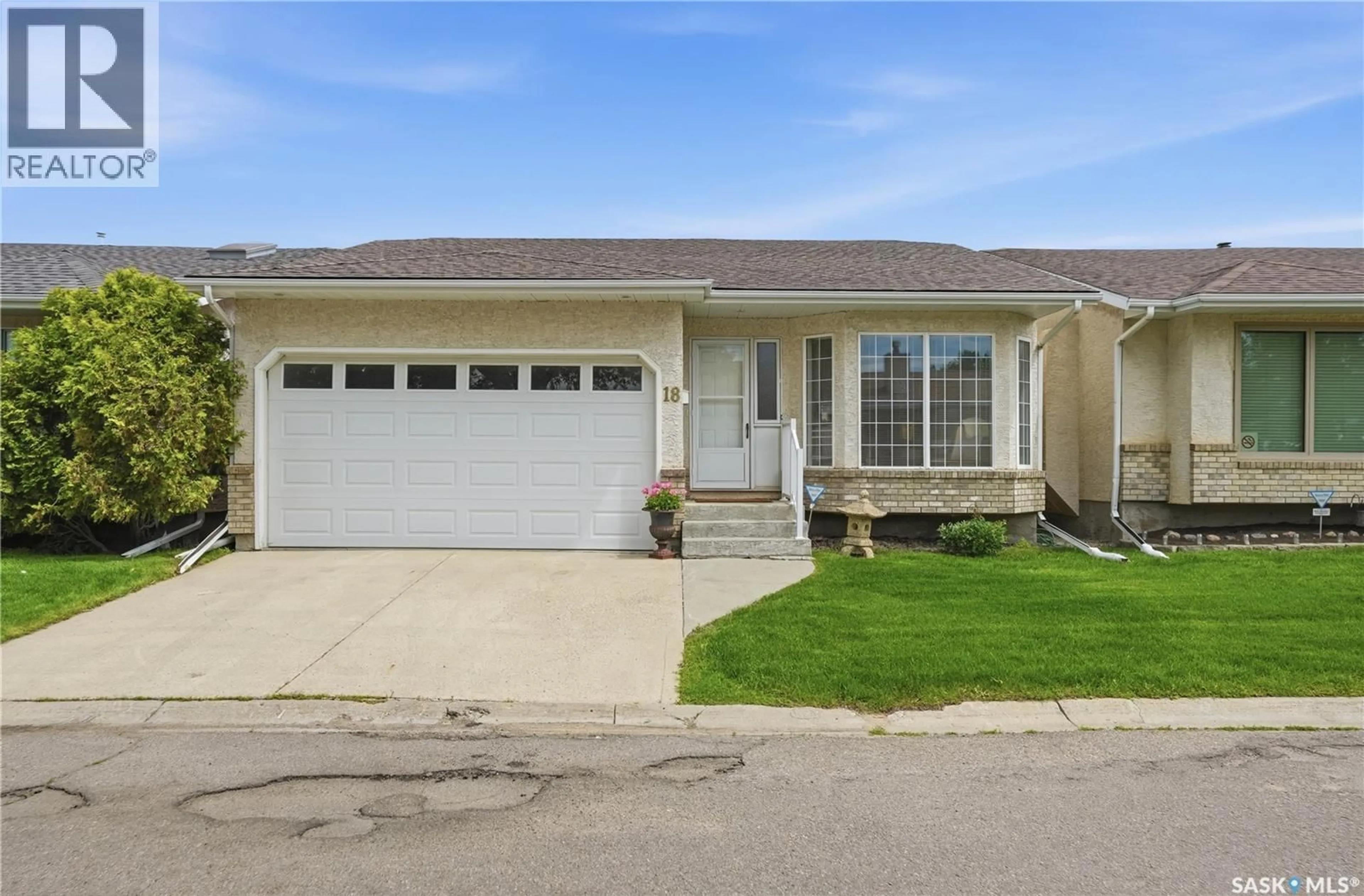 Home with vinyl exterior material, street for 18 GREENSBORO DRIVE, Regina Saskatchewan S4S7G1