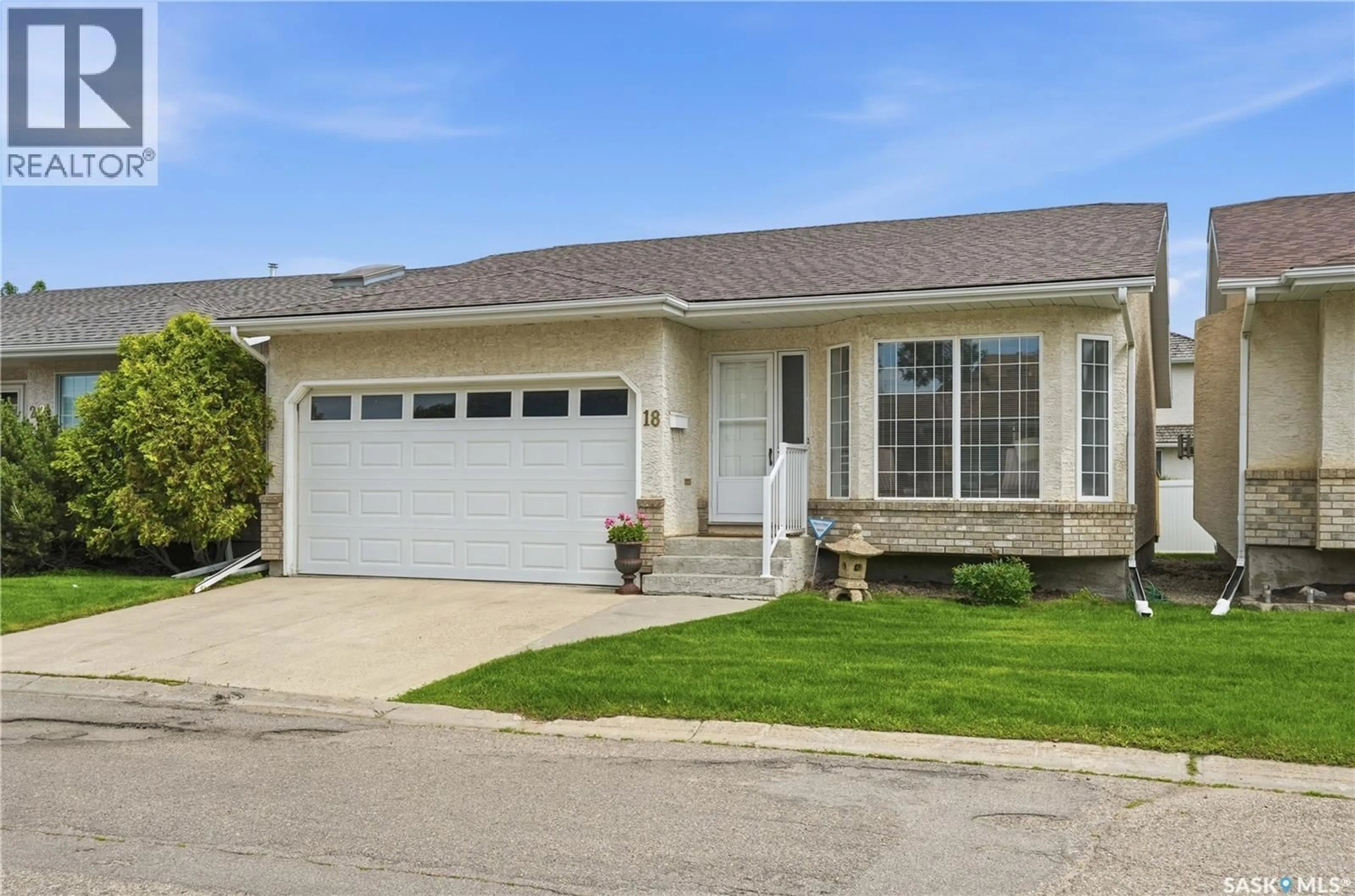 Home with vinyl exterior material, street for 18 GREENSBORO DRIVE, Regina Saskatchewan S4S7G1