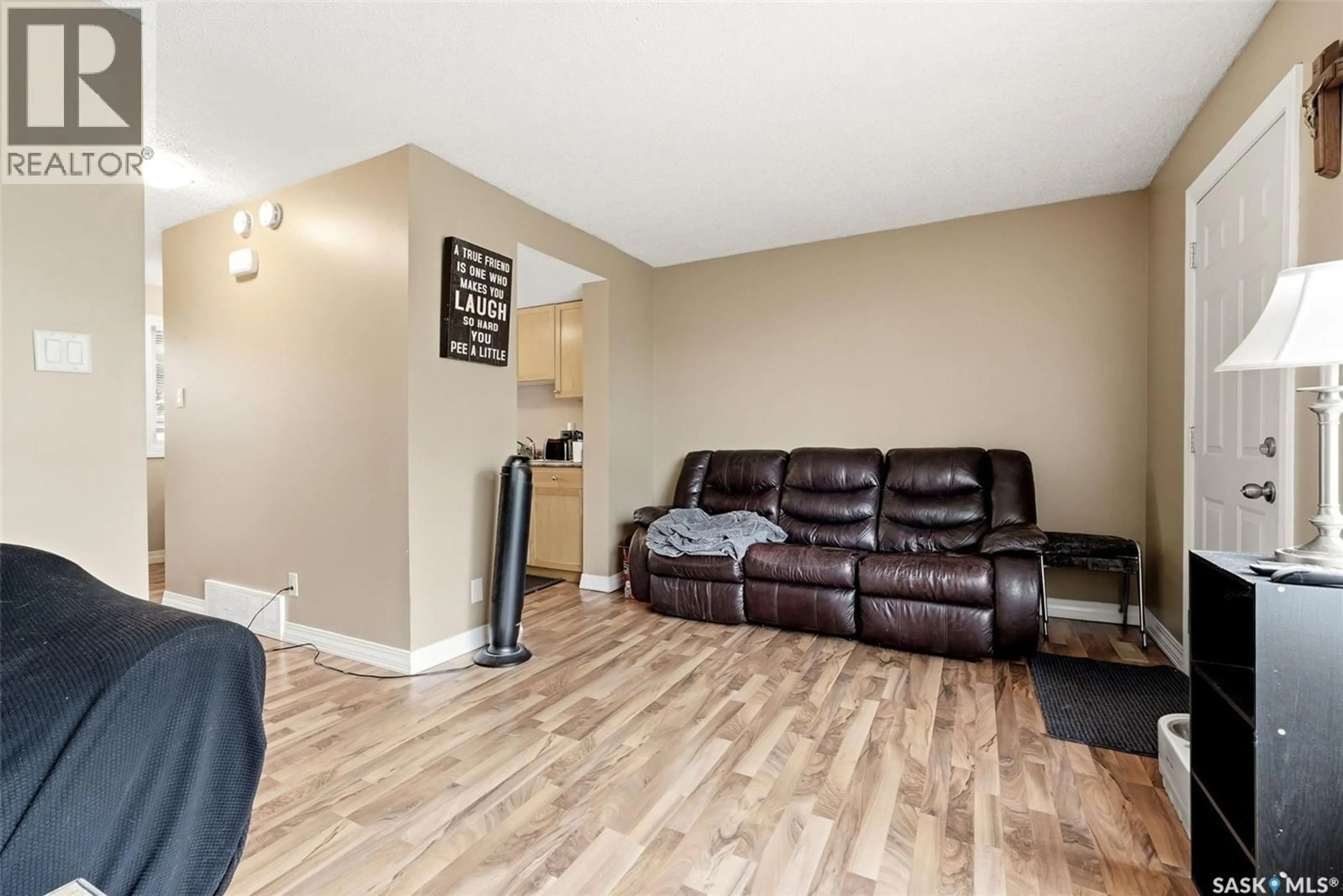 Living room with furniture, wood/laminate floor for 3828 CASTLE ROAD, Regina Saskatchewan S4S6M7