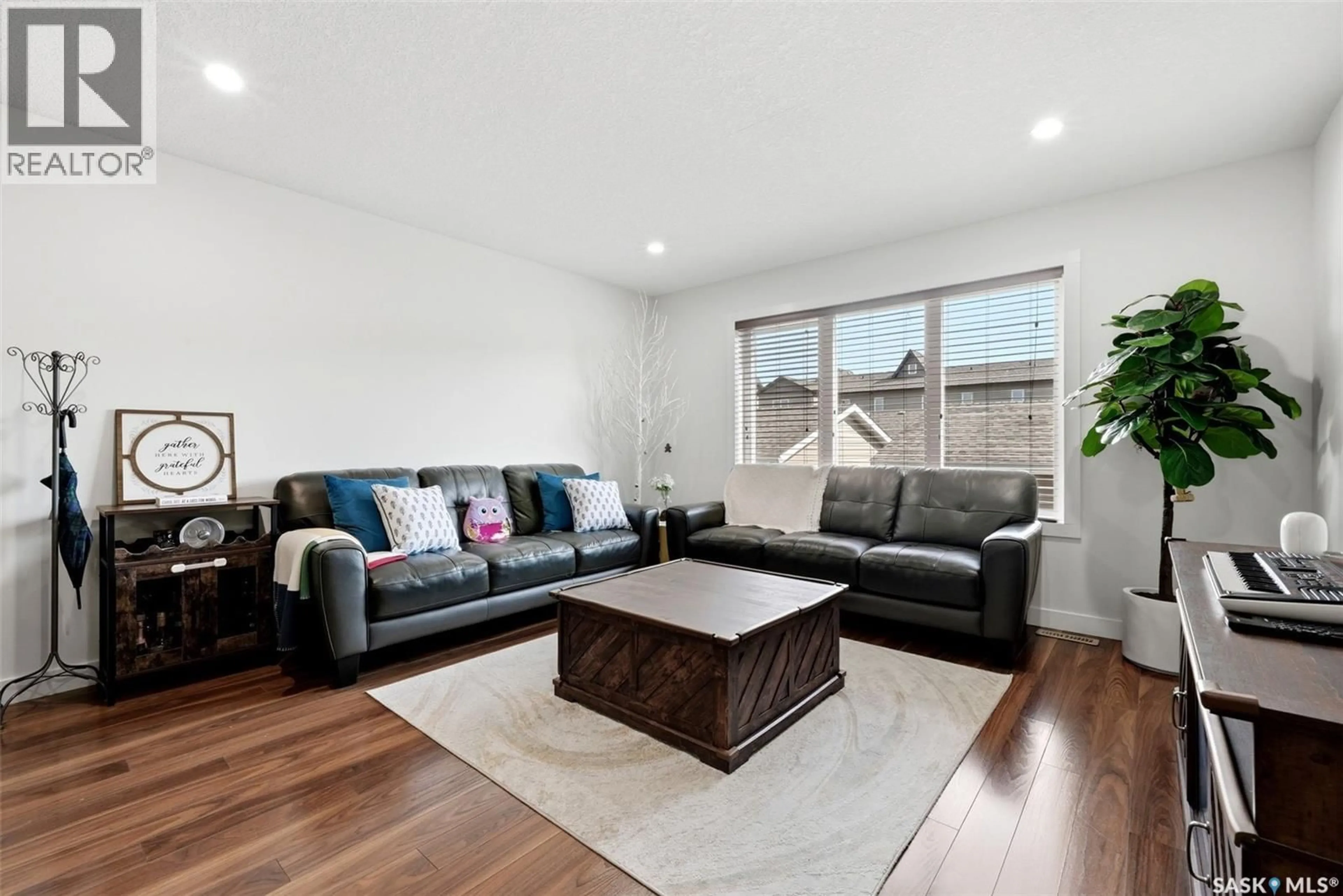 Living room with furniture, wood/laminate floor for 5325 JIM CAIRNS BOULEVARD, Regina Saskatchewan S4W0G1