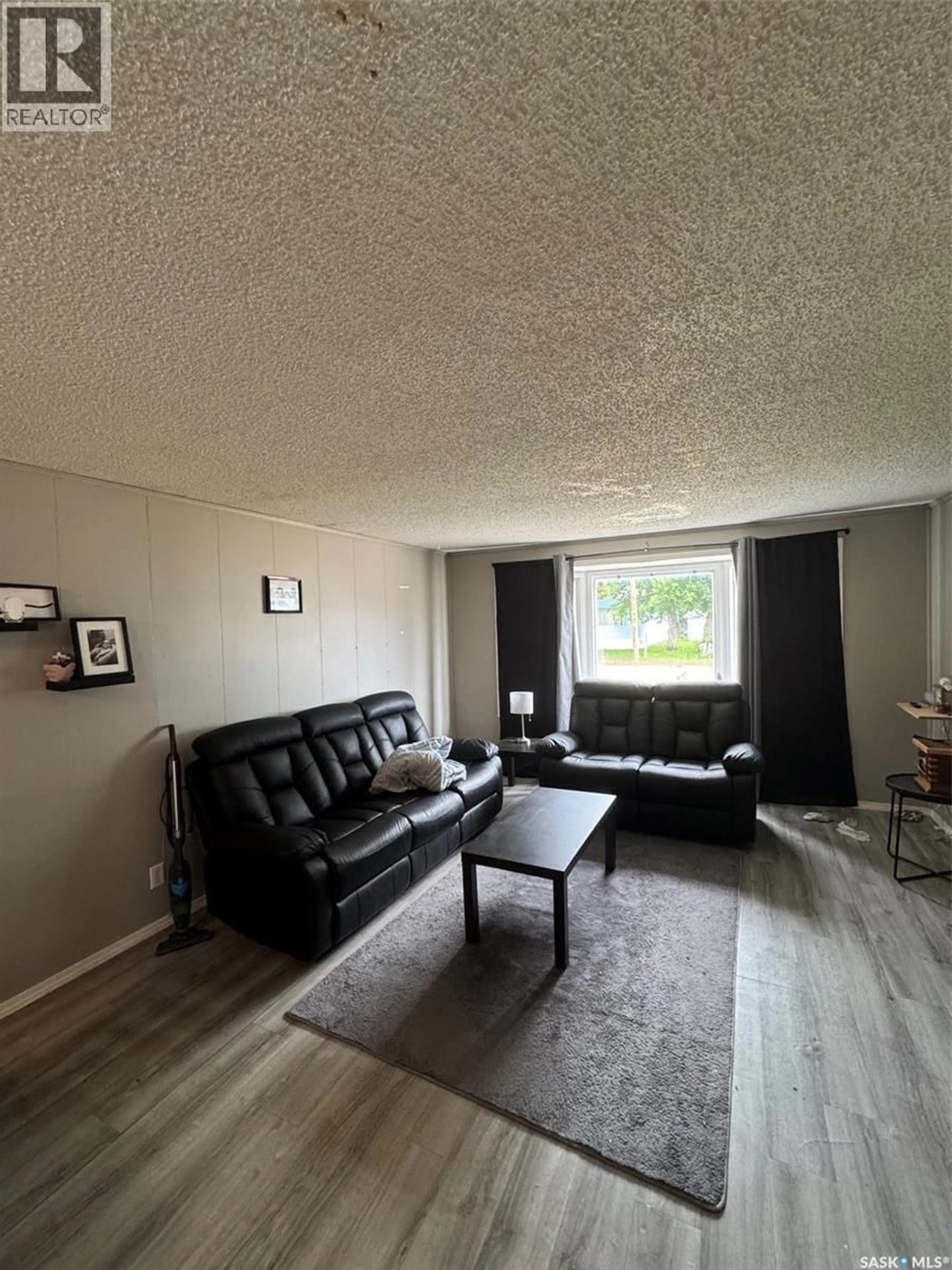 Living room with furniture, wood/laminate floor for 451 34TH STREET, Battleford Saskatchewan S0M0E0