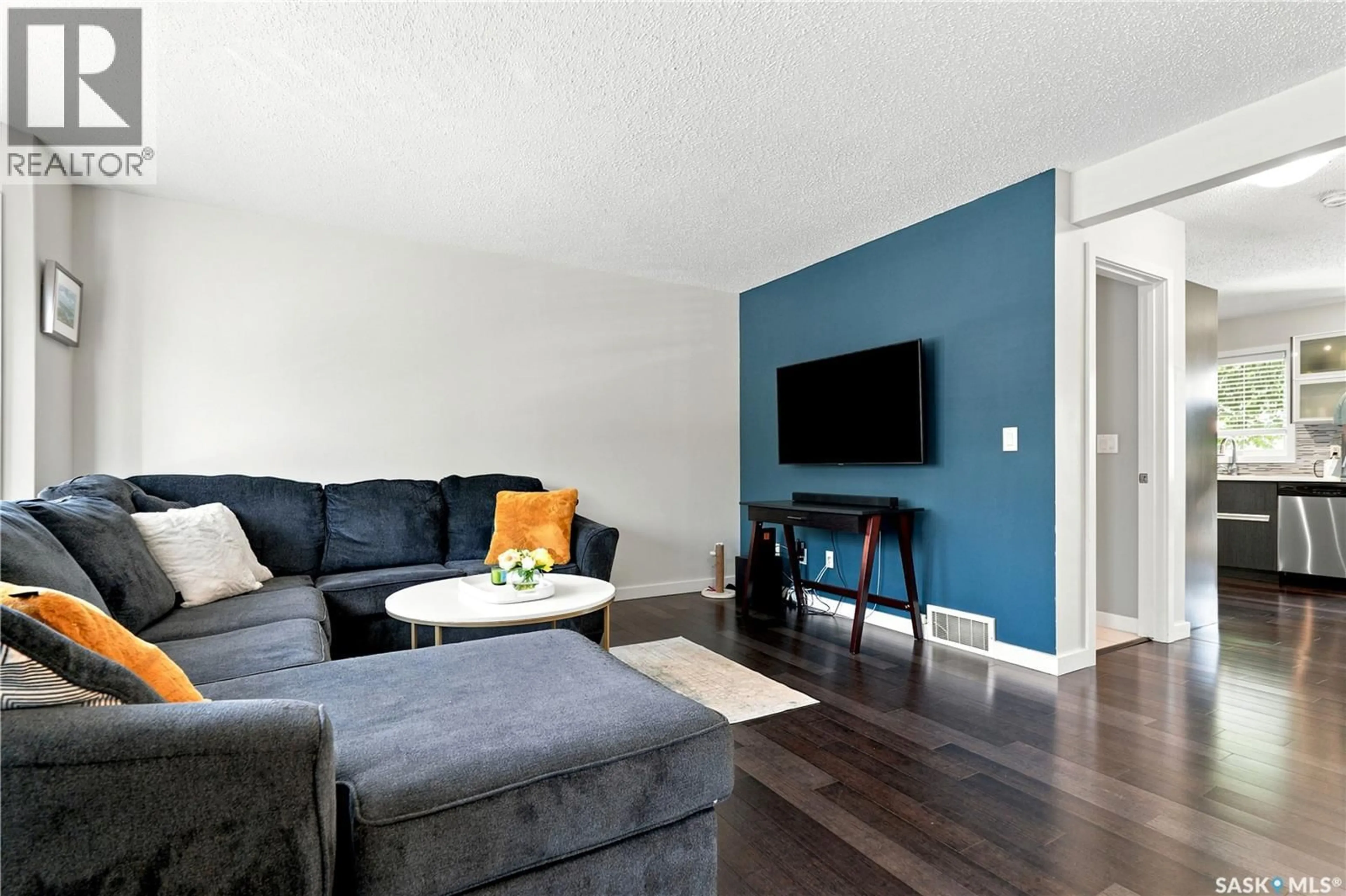 Living room with furniture, wood/laminate floor for 163 135 ASHWORTH CRESCENT, Saskatoon Saskatchewan S7T0N1