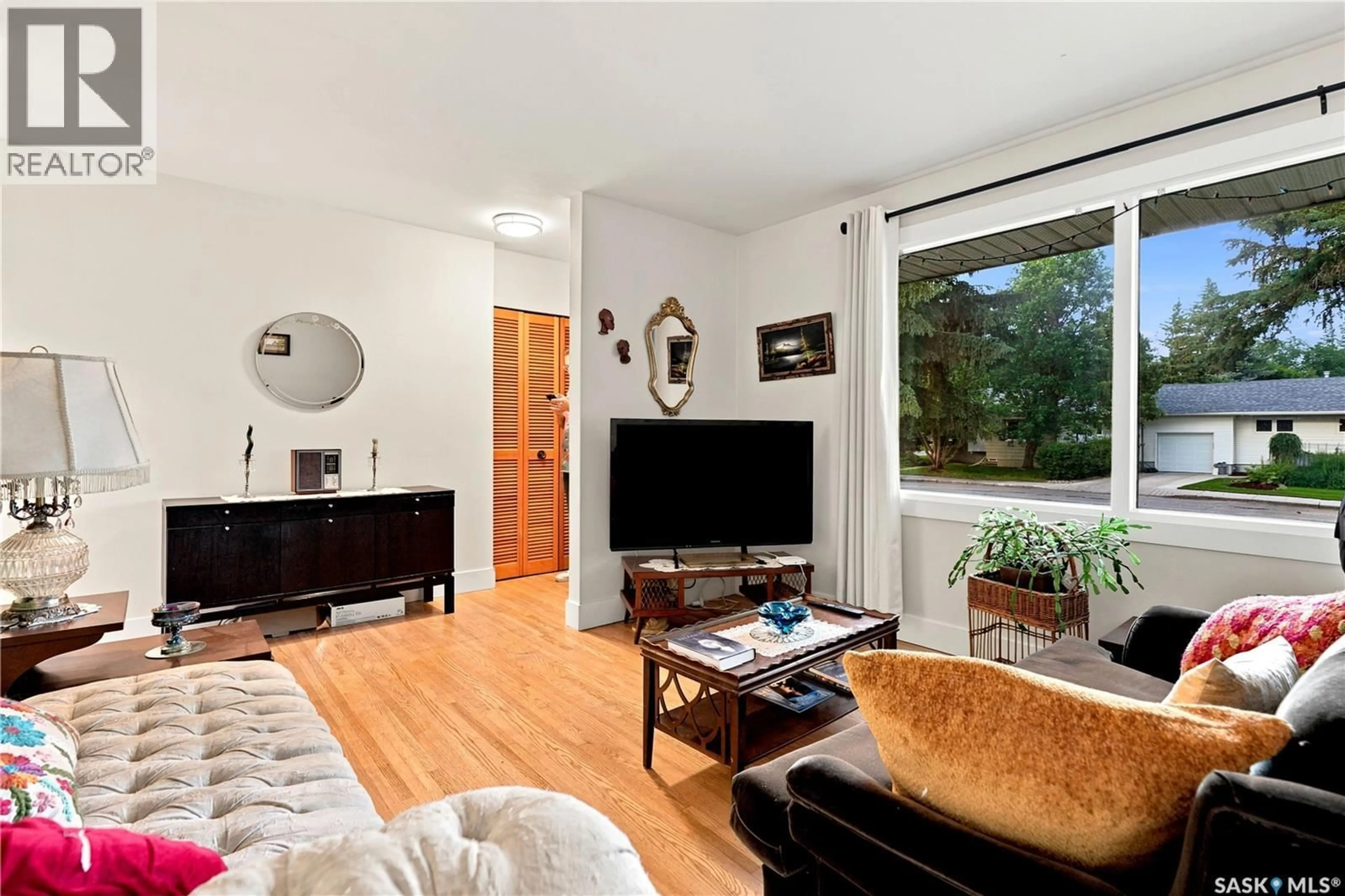 Living room with furniture, wood/laminate floor for 1706 EWART AVENUE, Saskatoon Saskatchewan S7H2L2