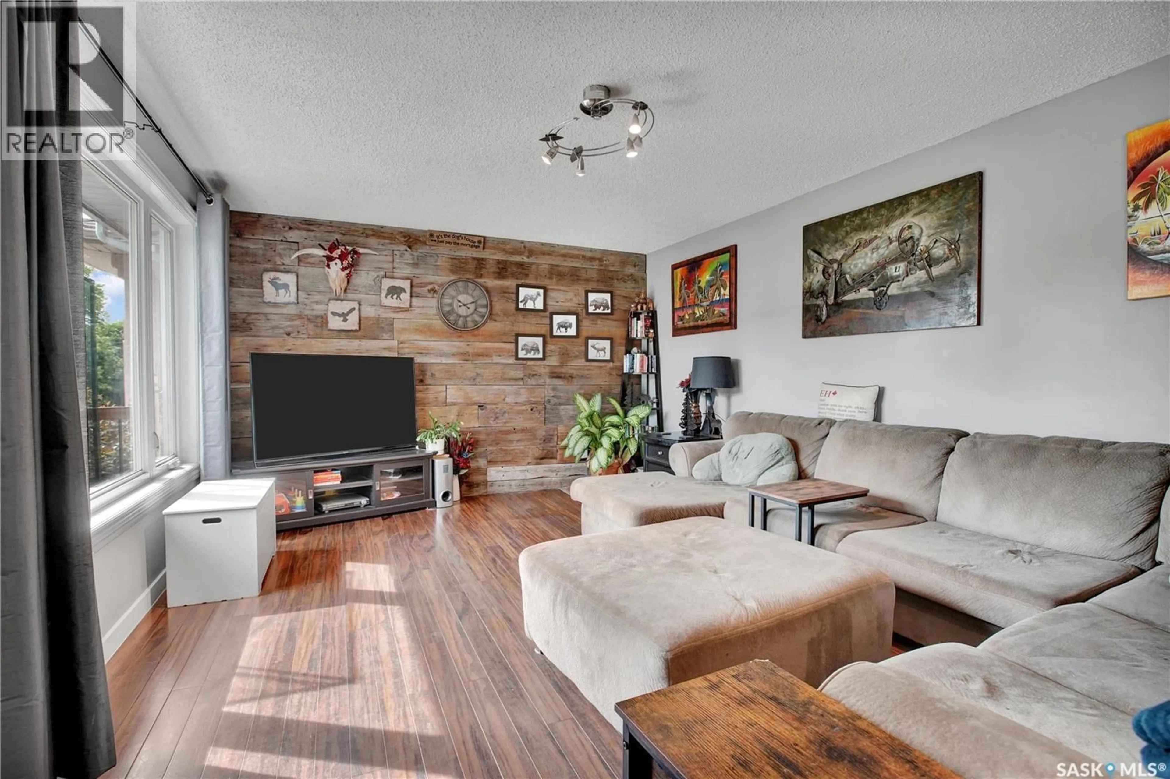 Living room with furniture, wood/laminate floor for 1515 CRERAR DRIVE, Saskatoon Saskatchewan S7M4R8