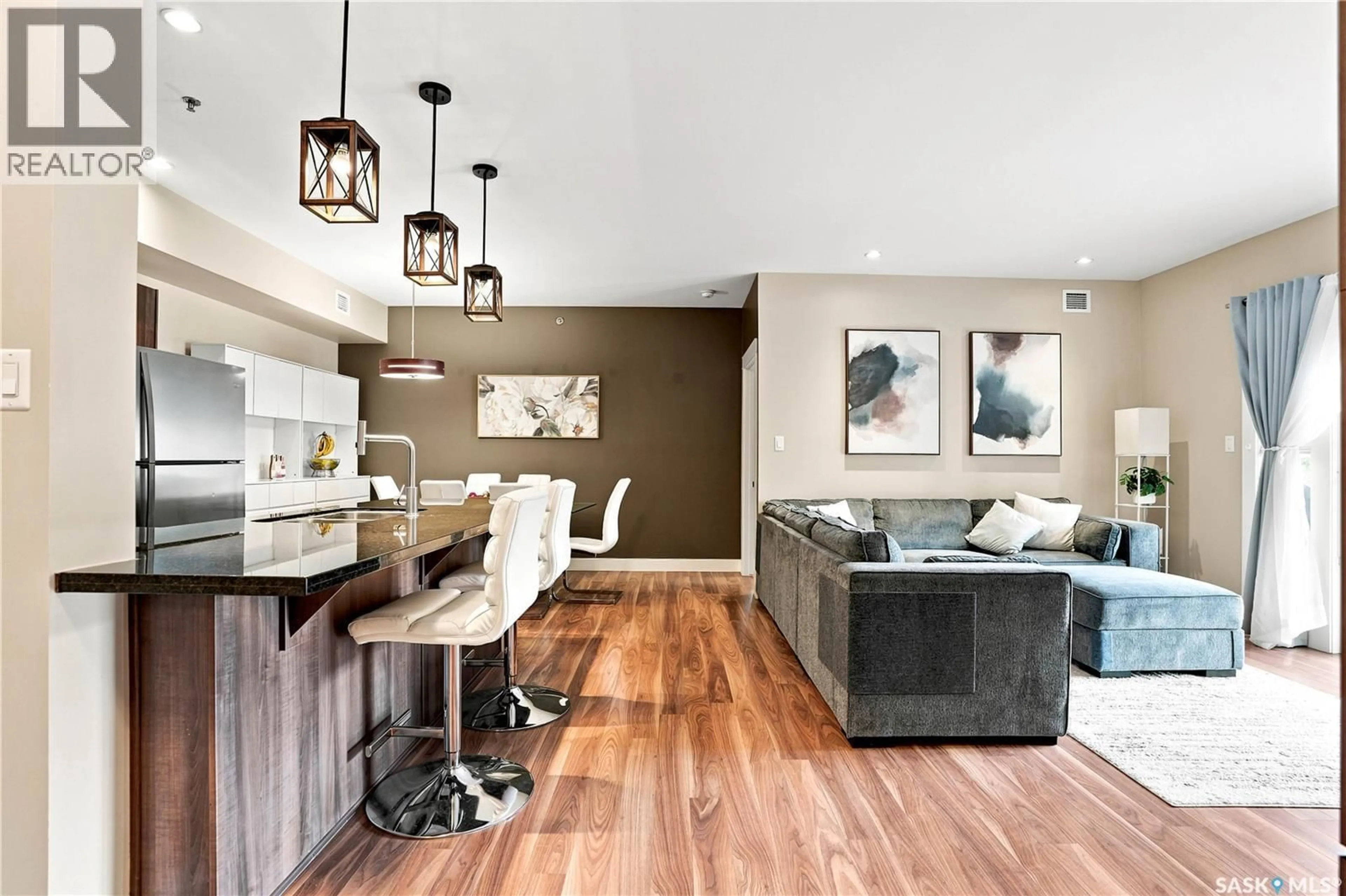 Open concept kitchen, wood/laminate floor for 203 - 721 8TH STREET, Saskatoon Saskatchewan S7H0R4