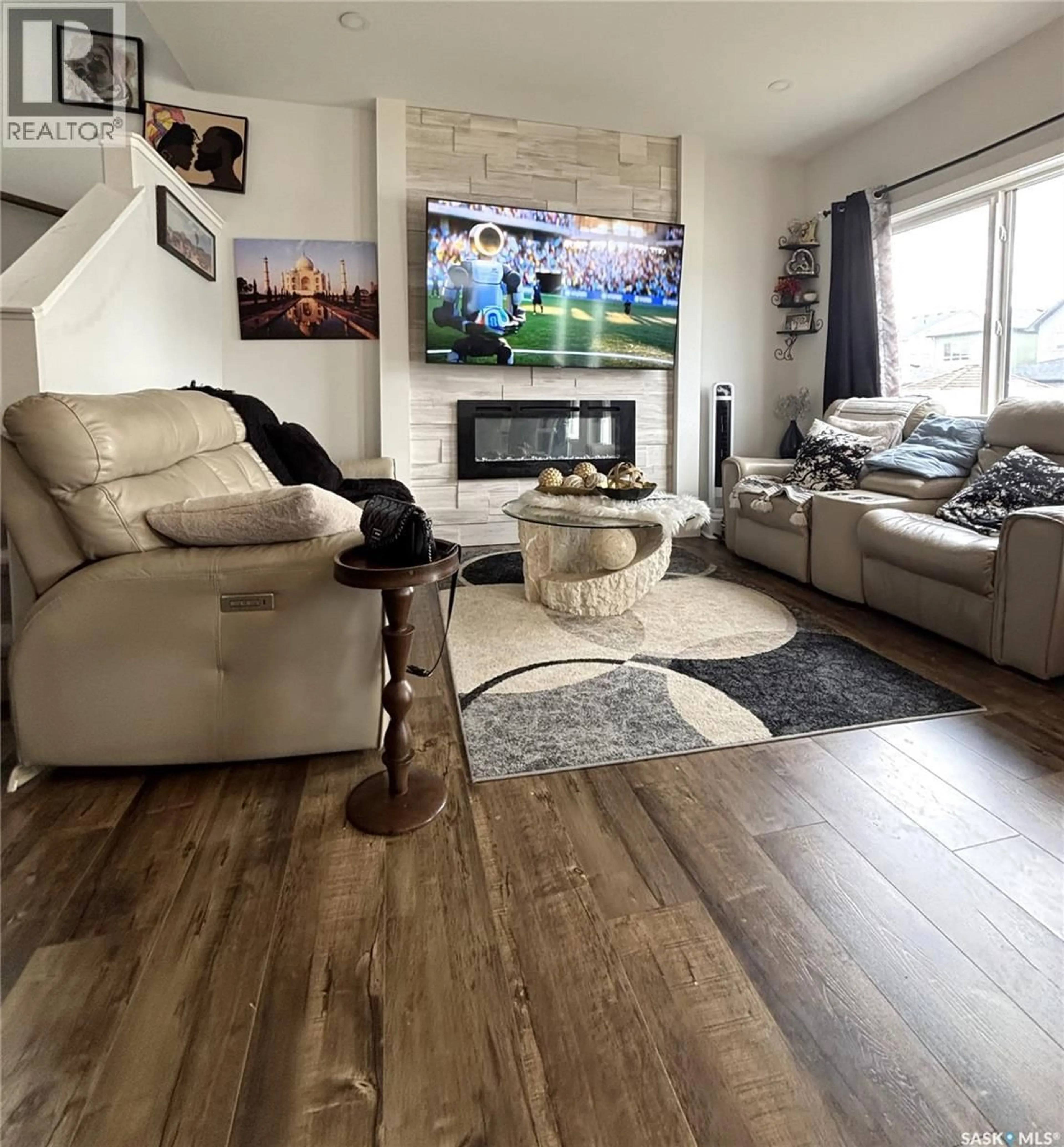 Living room with furniture, wood/laminate floor for 254 ANISKOTAW MANOR, Saskatoon Saskatchewan S7V1L9