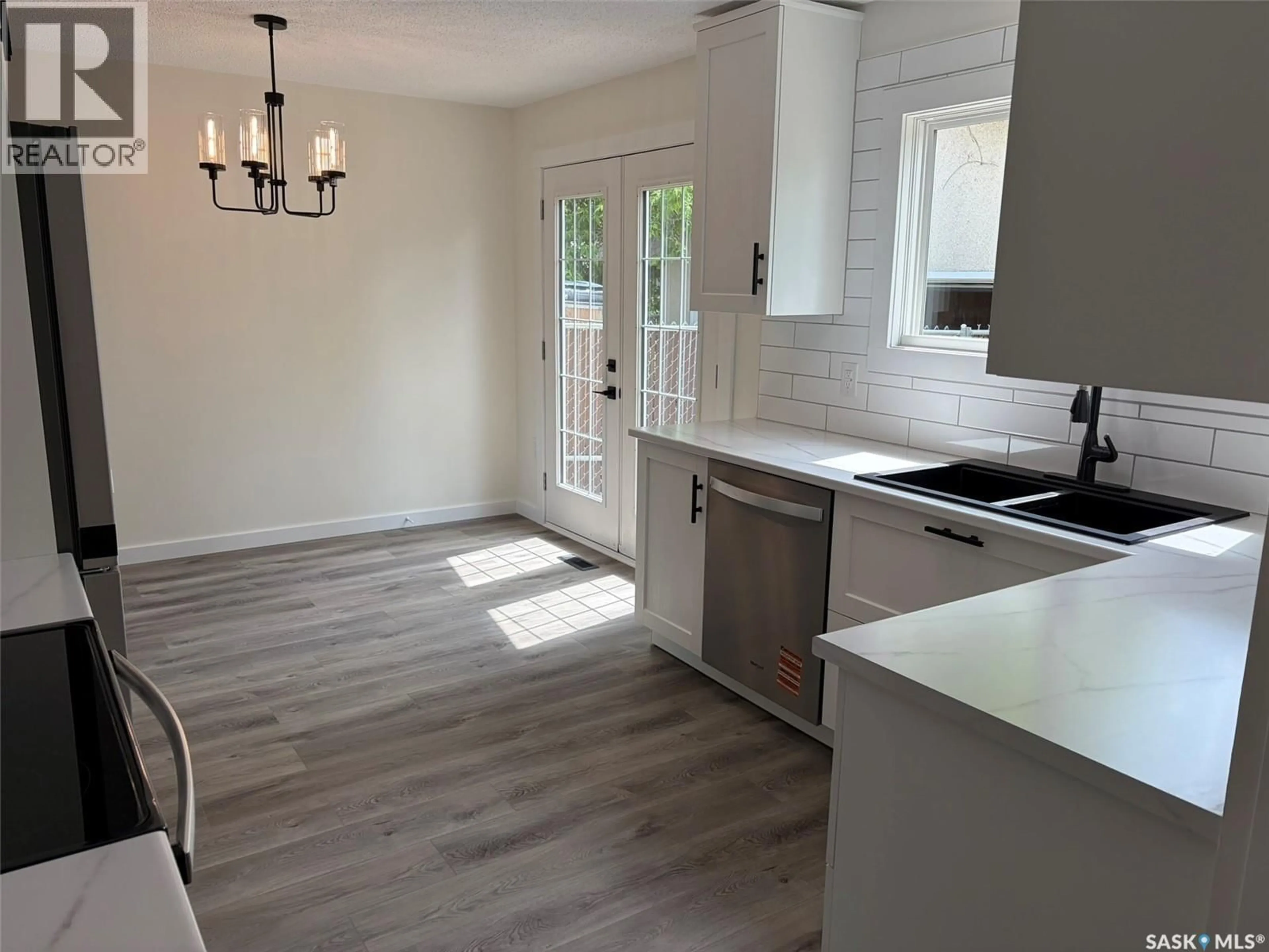 Open concept kitchen, wood/laminate floor for 565 32ND STREET, Prince Albert Saskatchewan S6V6B7