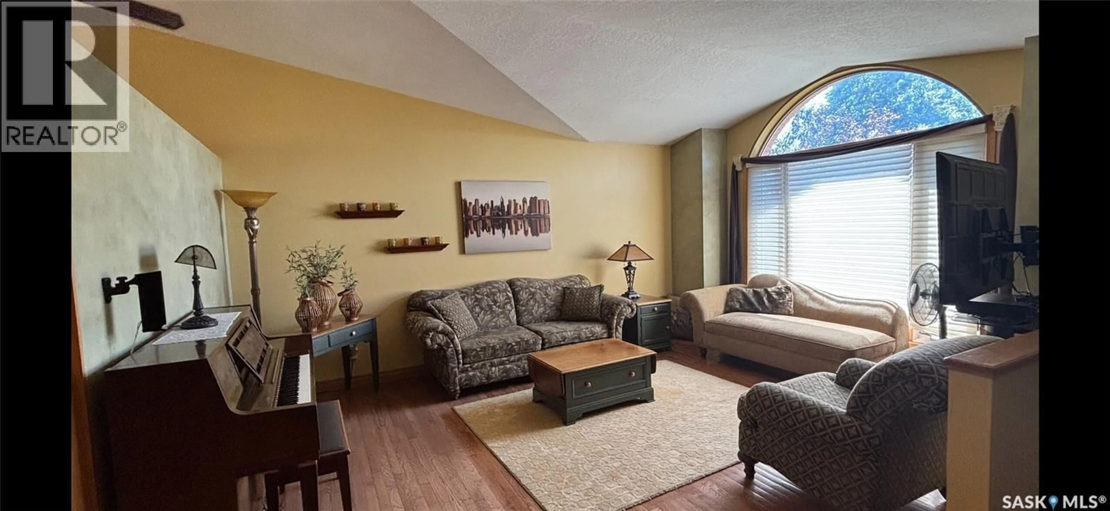 Living room with furniture, wood/laminate floor for 8214 RANKIN DRIVE, Regina Saskatchewan S4Y1J4