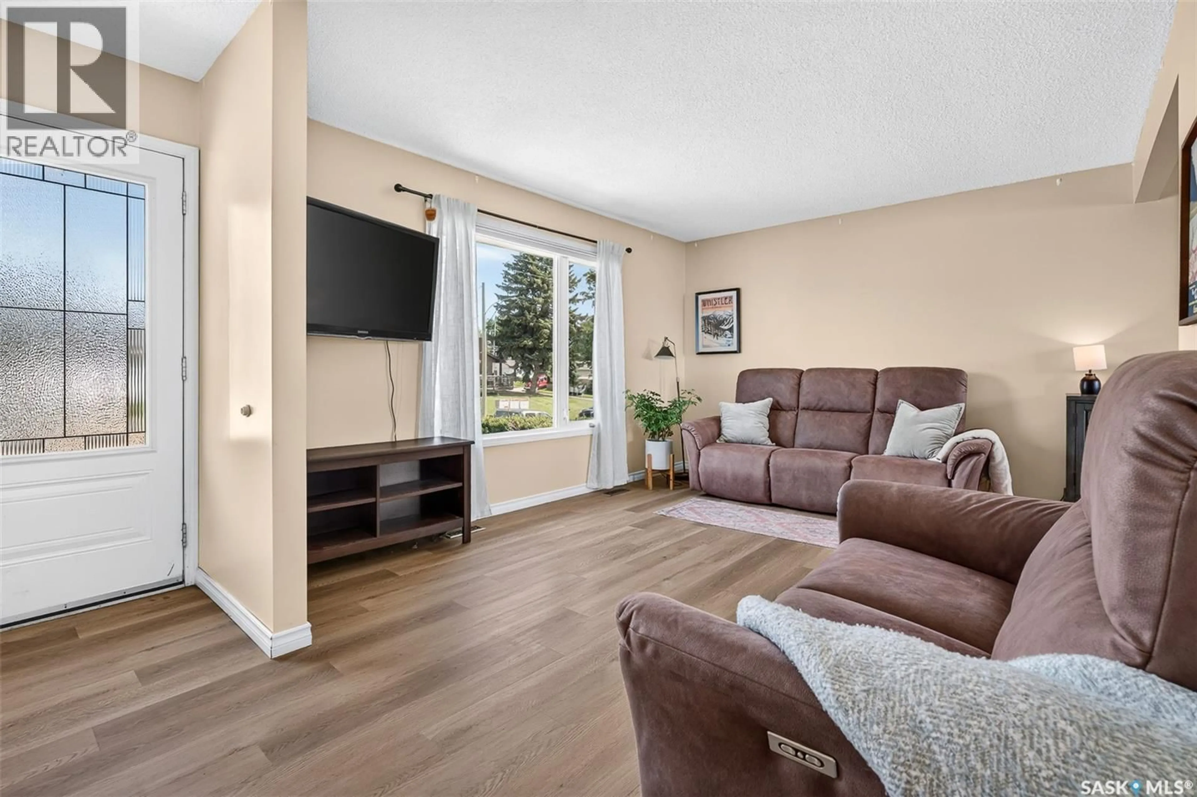 Living room with furniture, wood/laminate floor for 1311 STADACONA STREET, Moose Jaw Saskatchewan S6H6L4