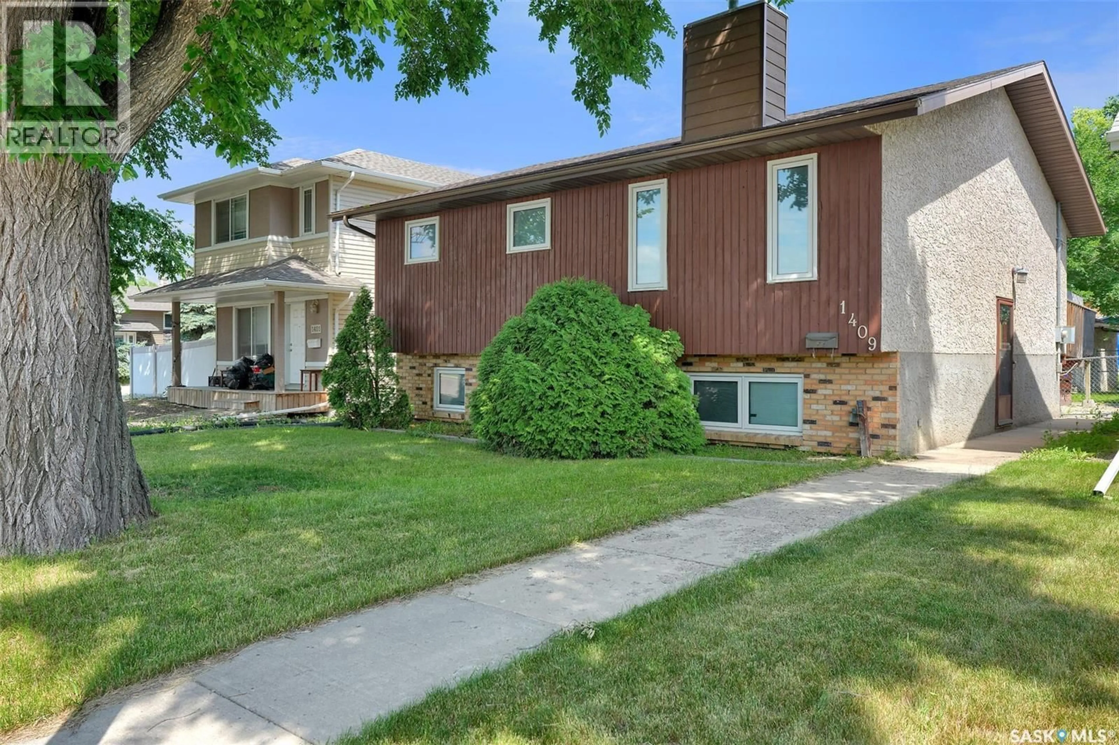 Home with brick exterior material, street for 1409 ROTHWELL STREET, Regina Saskatchewan S4N2B4