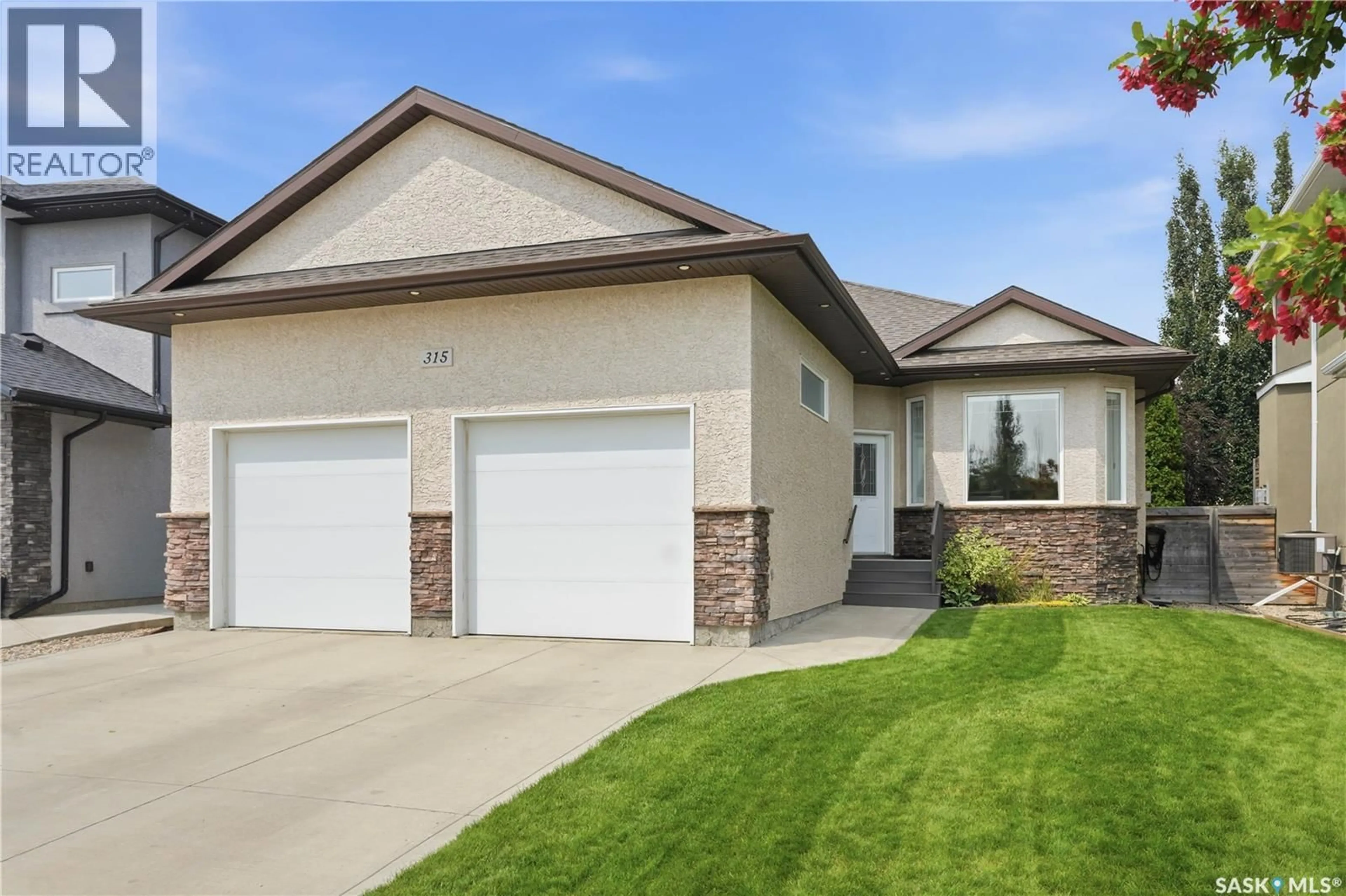 Home with vinyl exterior material, street for 315 WERSCHNER LANE, Saskatoon Saskatchewan S7V0C9