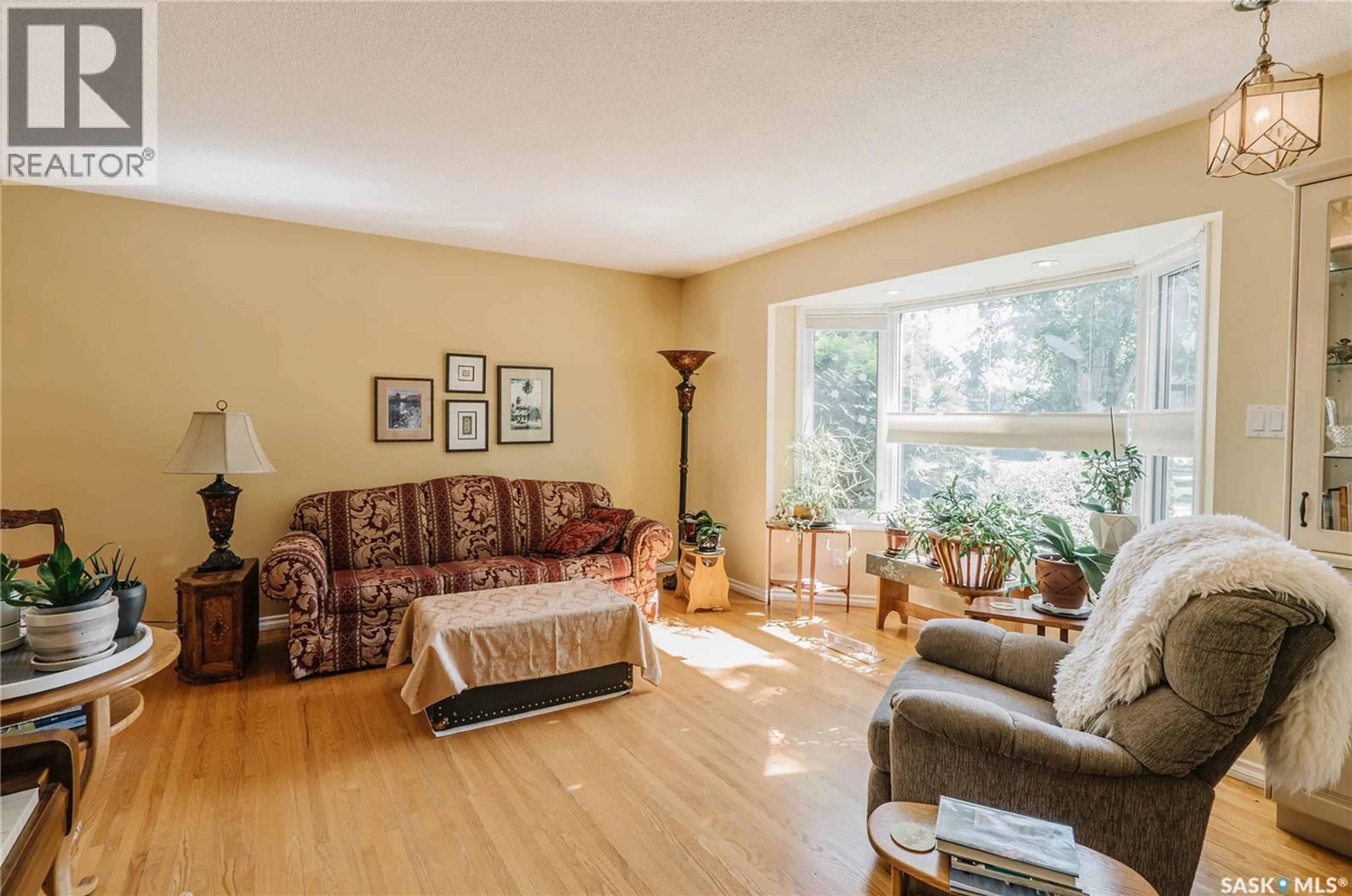 Living room with furniture, wood/laminate floor for 2704 PRESTON AVENUE, Saskatoon Saskatchewan S7J2G6