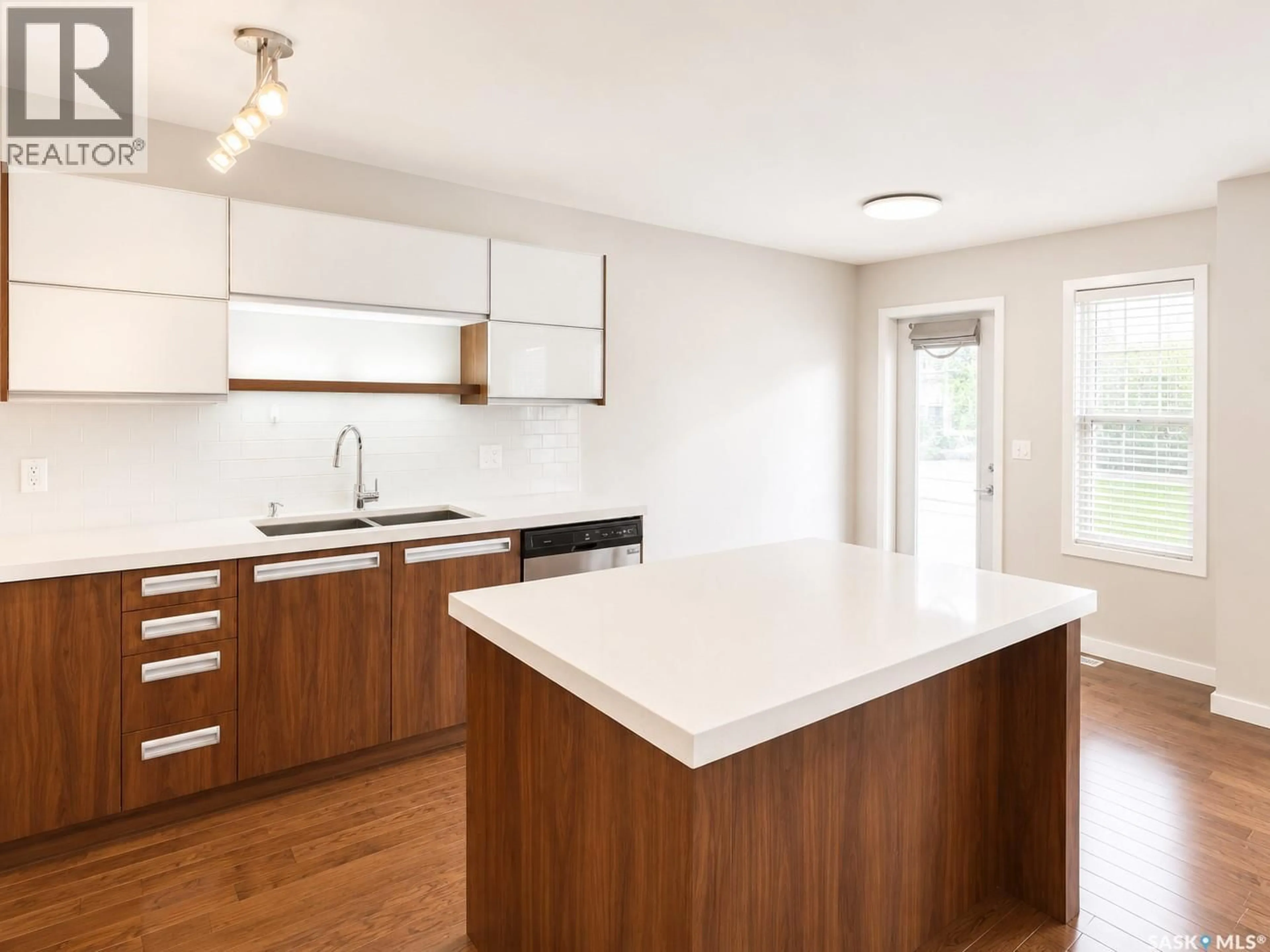 Open concept kitchen, wood/laminate floor for 405 455 REMPEL LANE, Saskatoon Saskatchewan S7T0R9