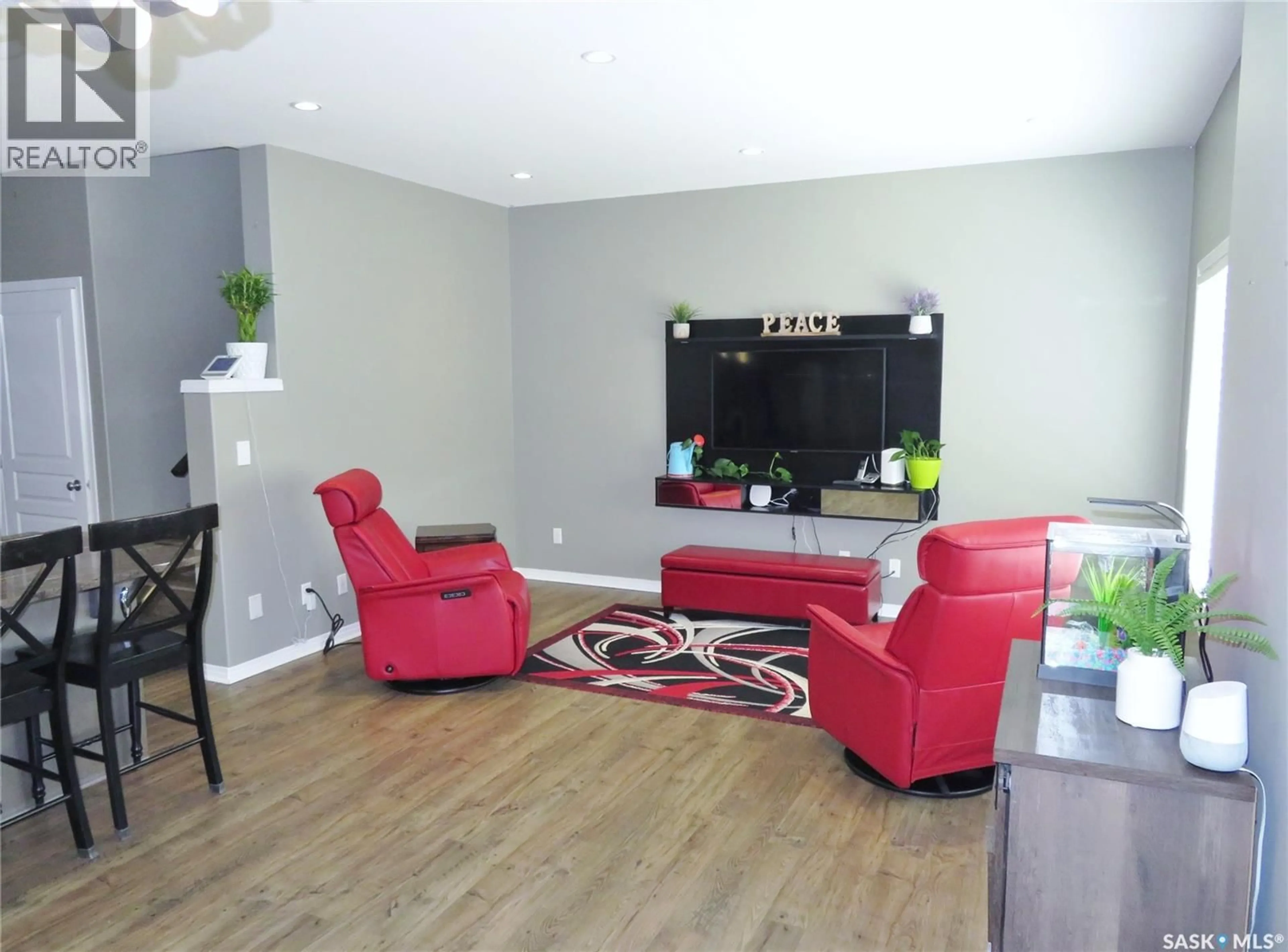 Living room with furniture, wood/laminate floor for 1214 REMPEL CRESCENT, Saskatoon Saskatchewan S7T0M2