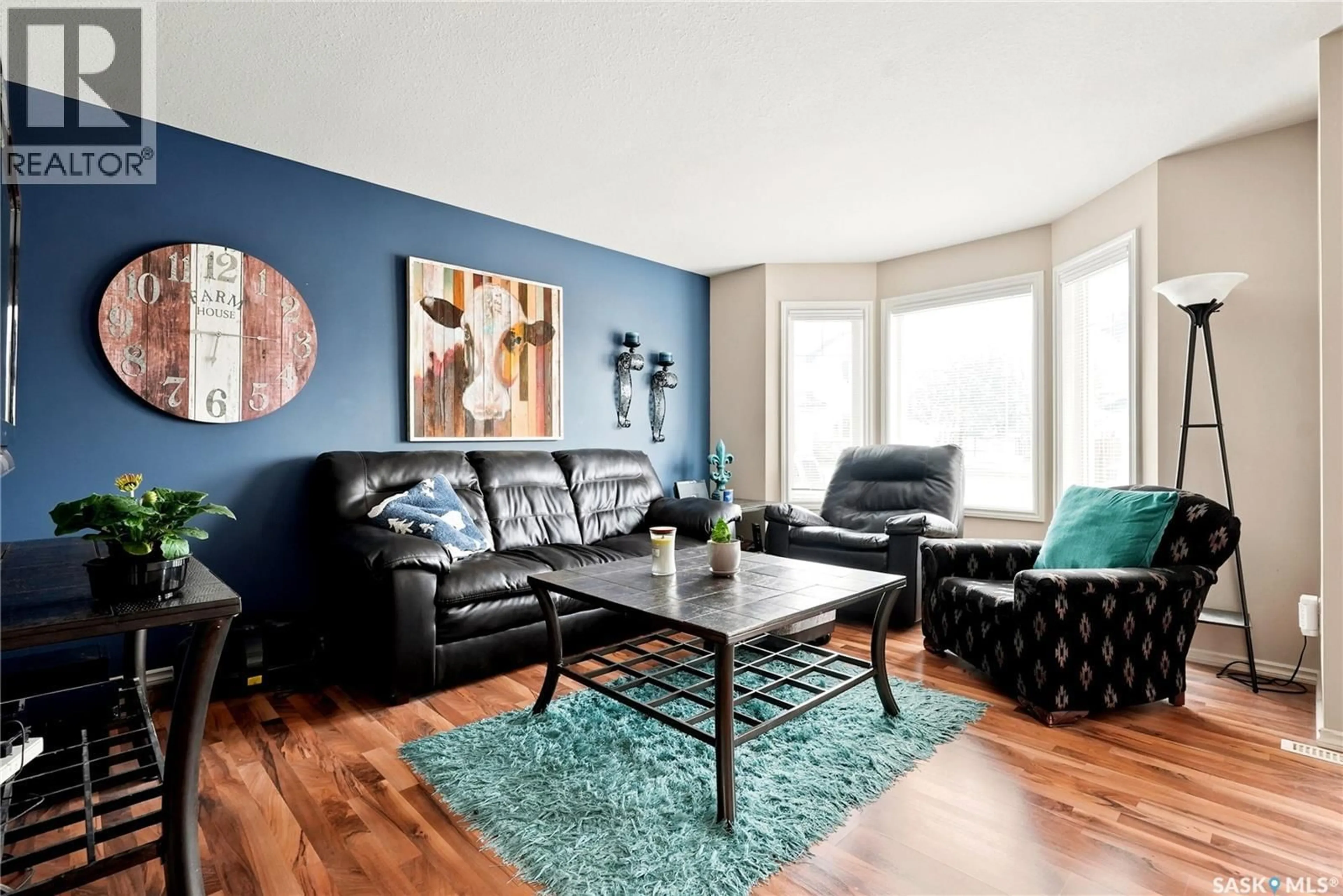 Living room with furniture, wood/laminate floor for 415 - 106 LYND CRESCENT, Saskatoon Saskatchewan S7T0C2