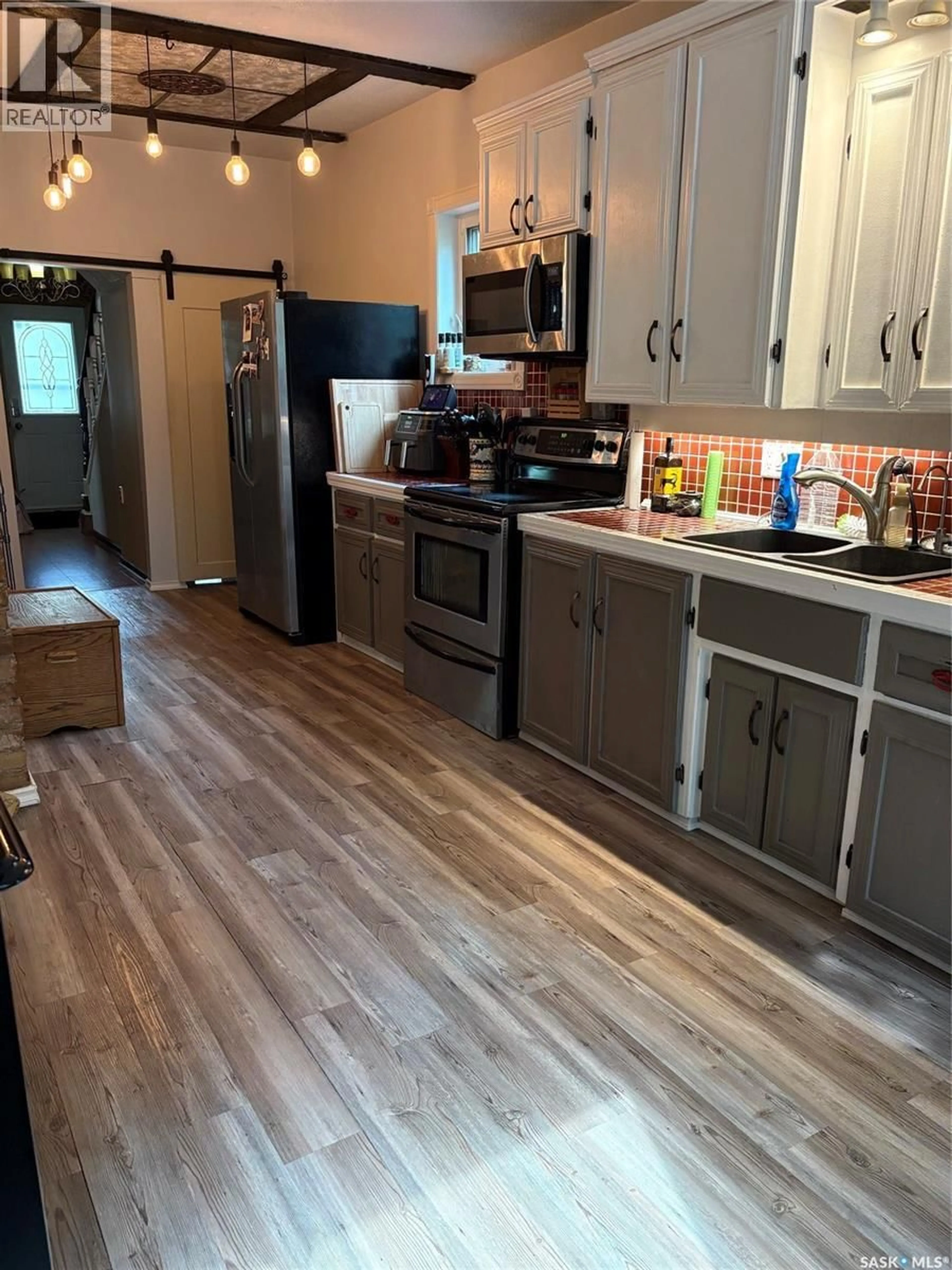 Open concept kitchen, wood/laminate floor for 67 SIXTH AVENUE, Yorkton Saskatchewan S3N0X7