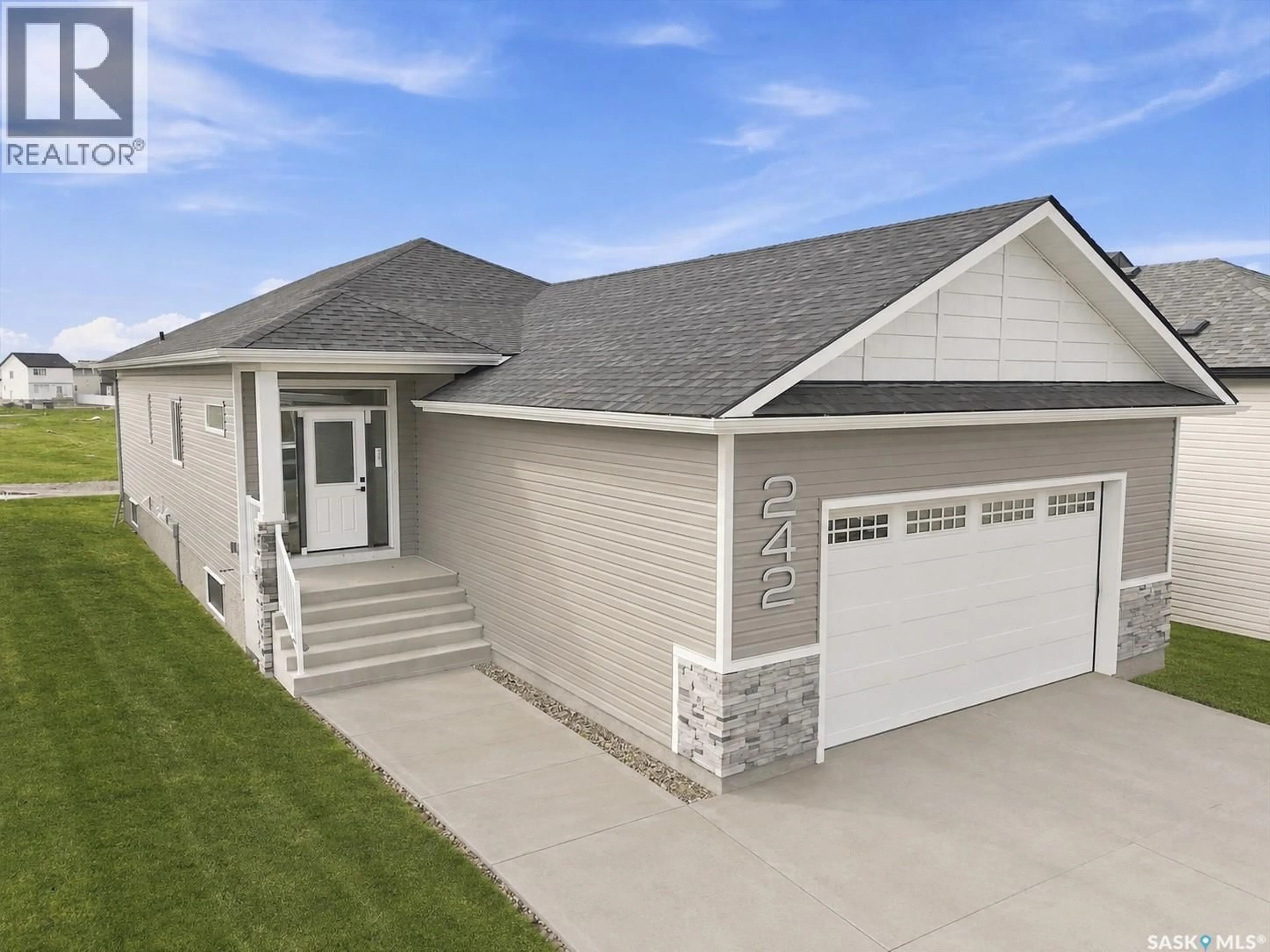 Home with vinyl exterior material, street for 242 DORAN WAY, Saskatoon Saskatchewan S7H4N2
