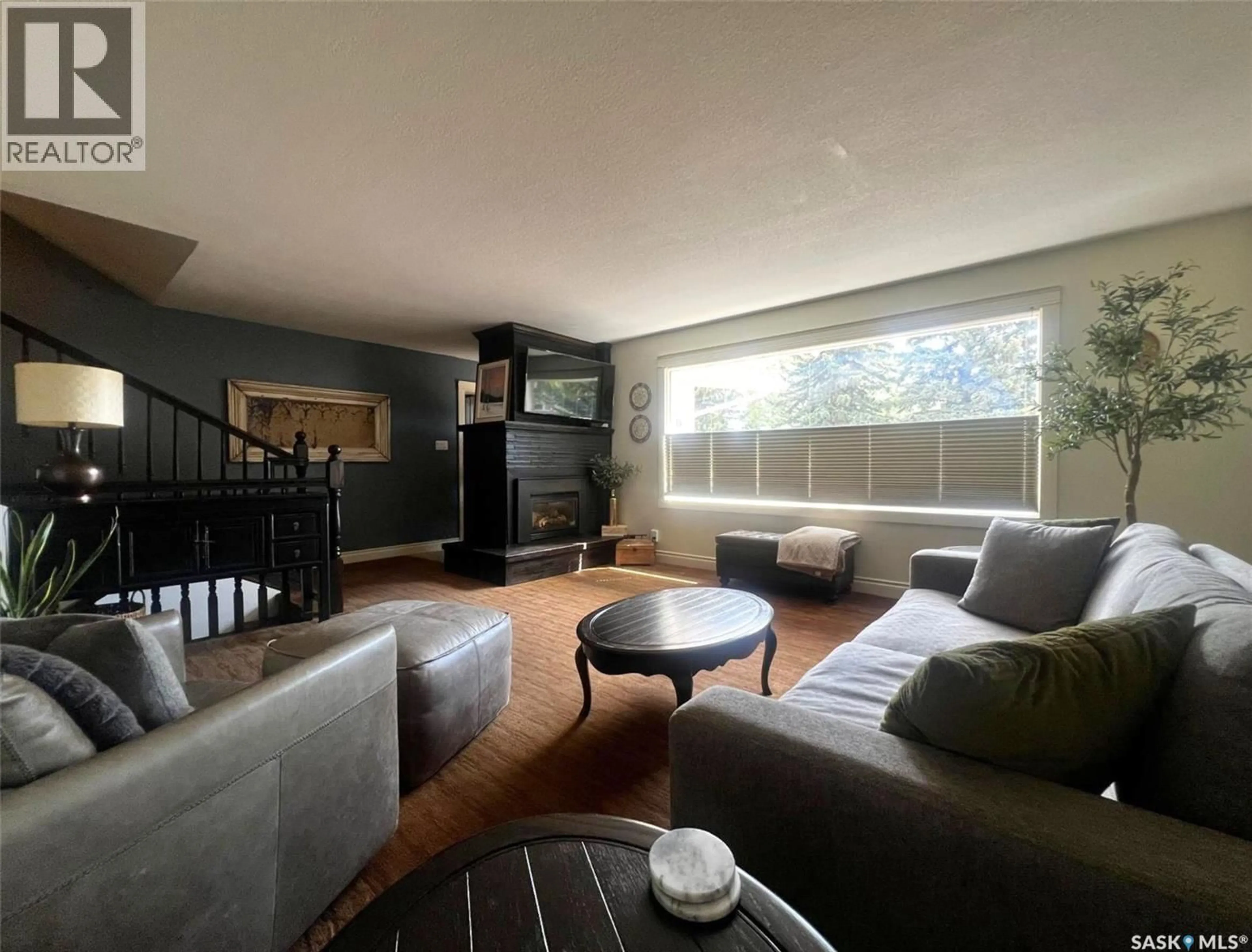 Living room with furniture, wood/laminate floor for E - 1183 GEORGE STREET, Swift Current Saskatchewan S9H1Z5