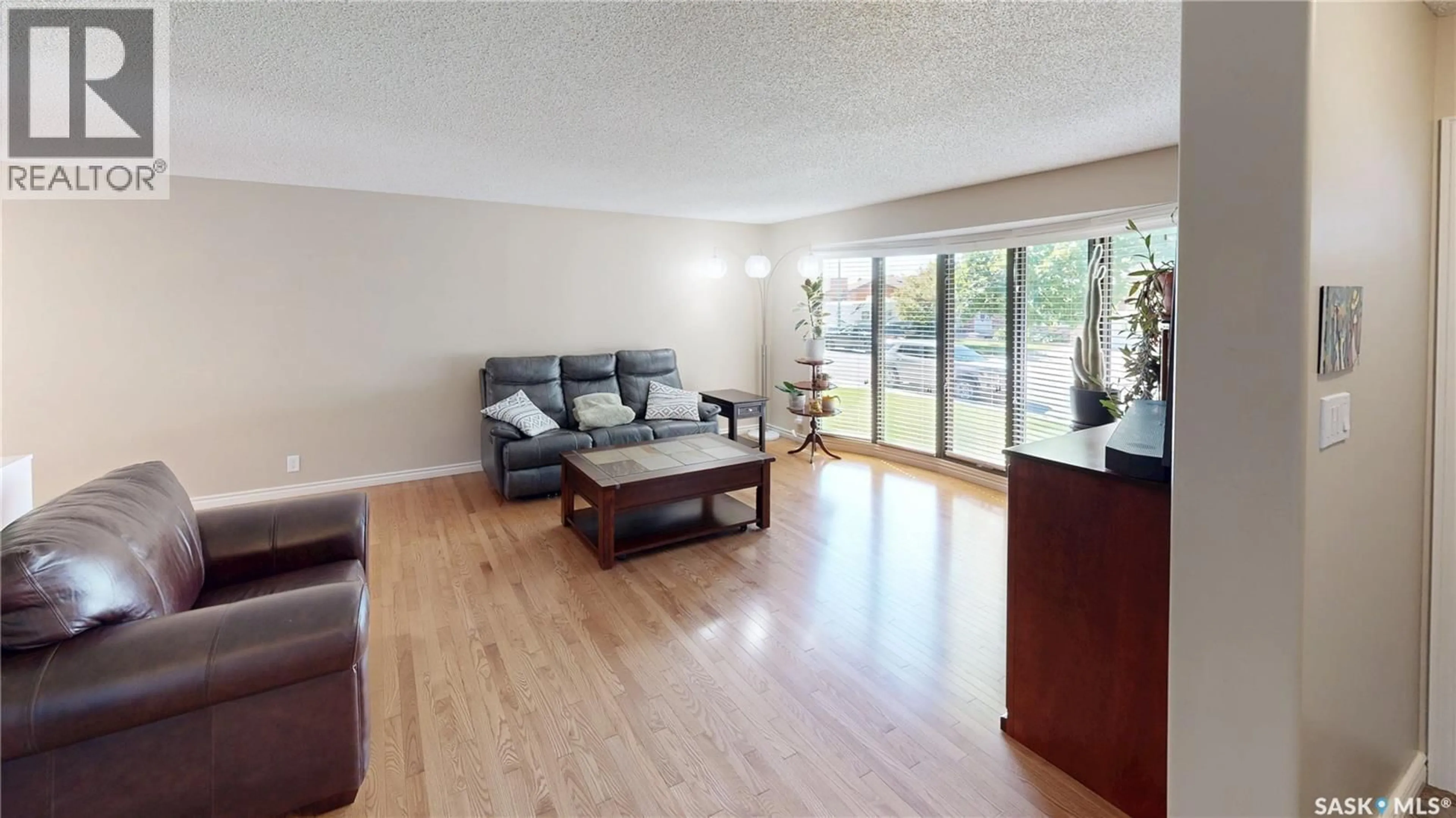Living room with furniture, wood/laminate floor for 70 HAWKES AVENUE, Regina Saskatchewan S4X1B4
