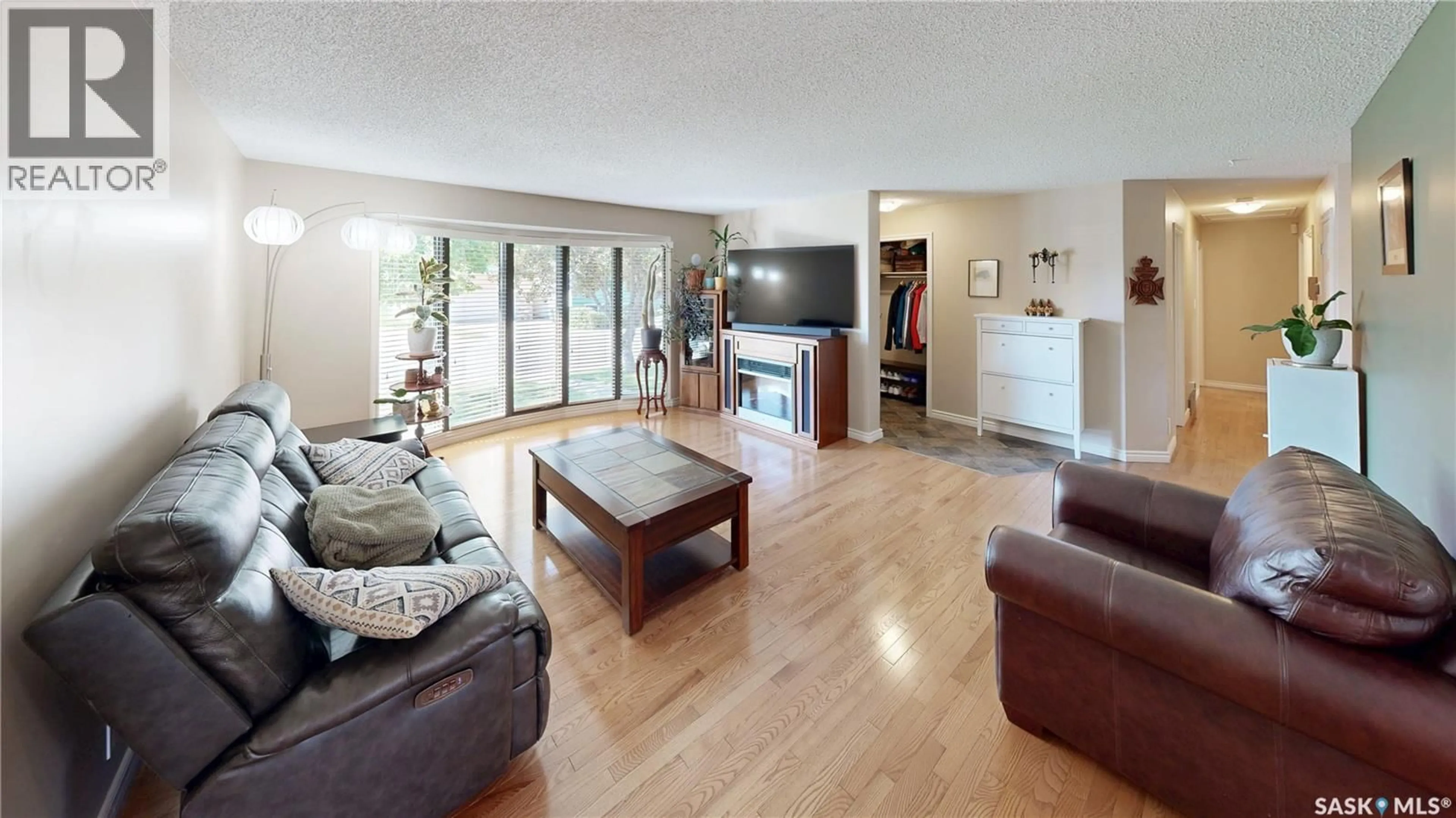 Living room with furniture, wood/laminate floor for 70 HAWKES AVENUE, Regina Saskatchewan S4X1B4