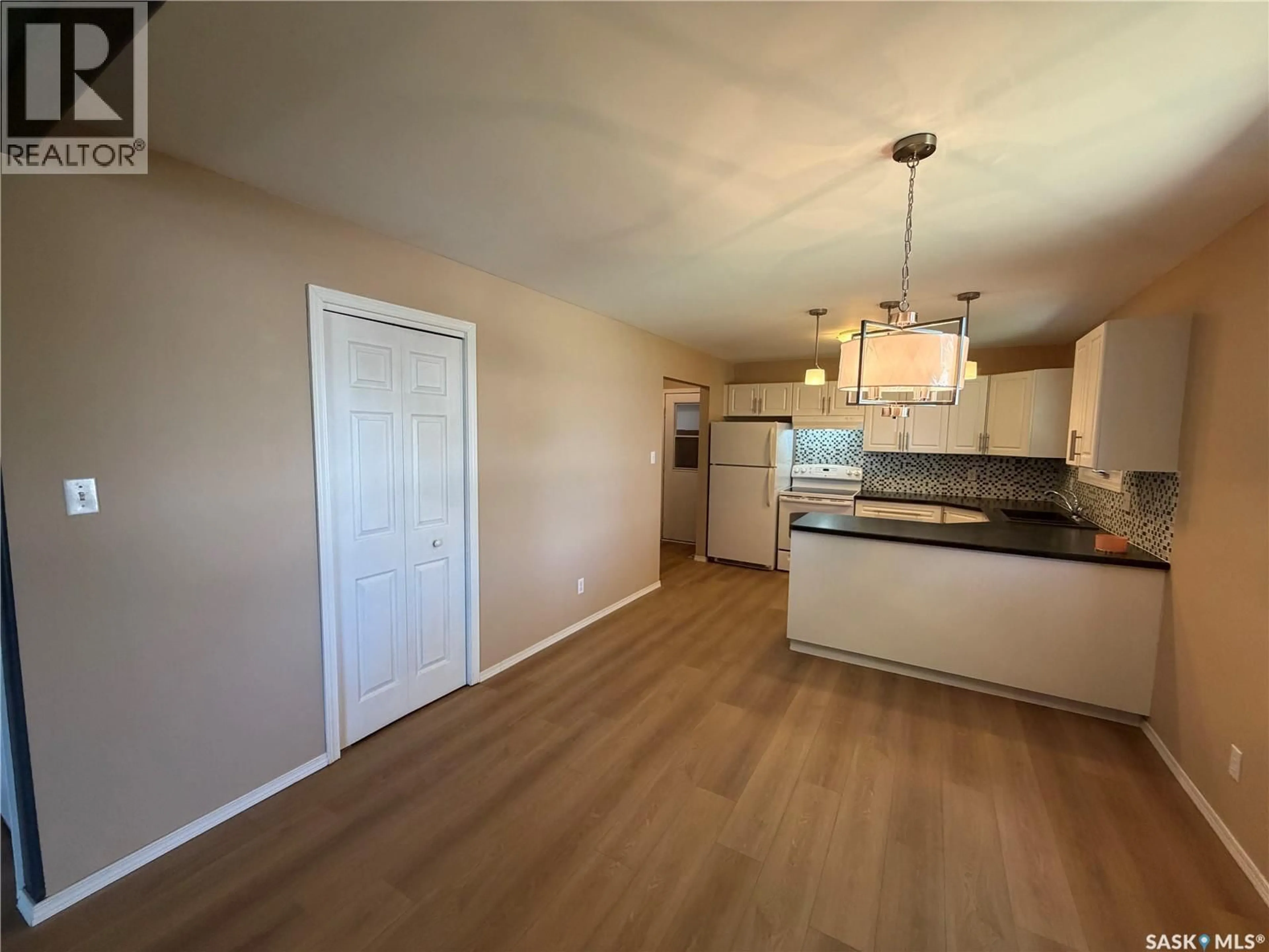 Open concept kitchen, wood/laminate floor for 25 SOURIS AVENUE, Redvers Saskatchewan S0C0A5