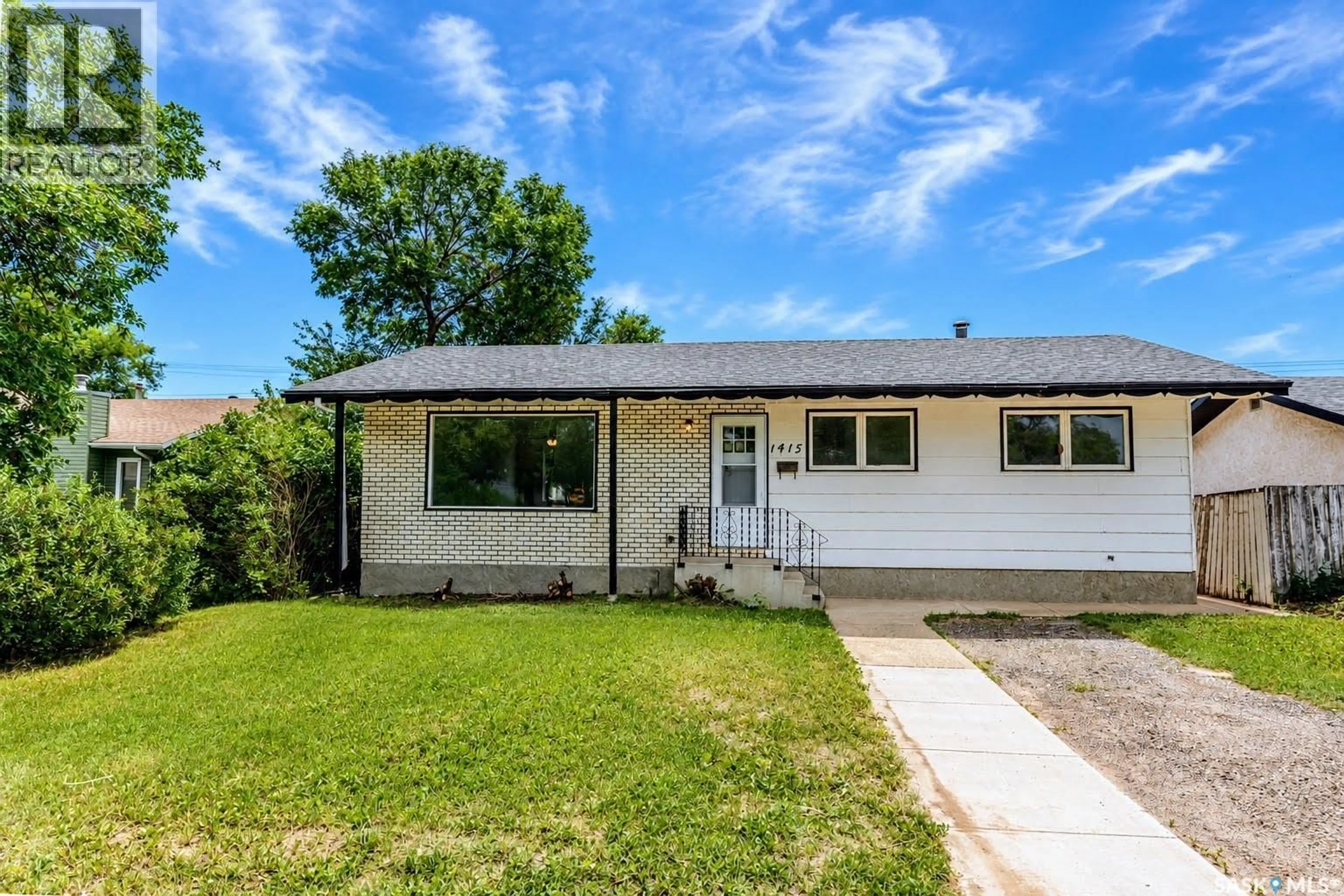Home with vinyl exterior material, street for 1415 CARIBOU STREET, Moose Jaw Saskatchewan S6H7M4