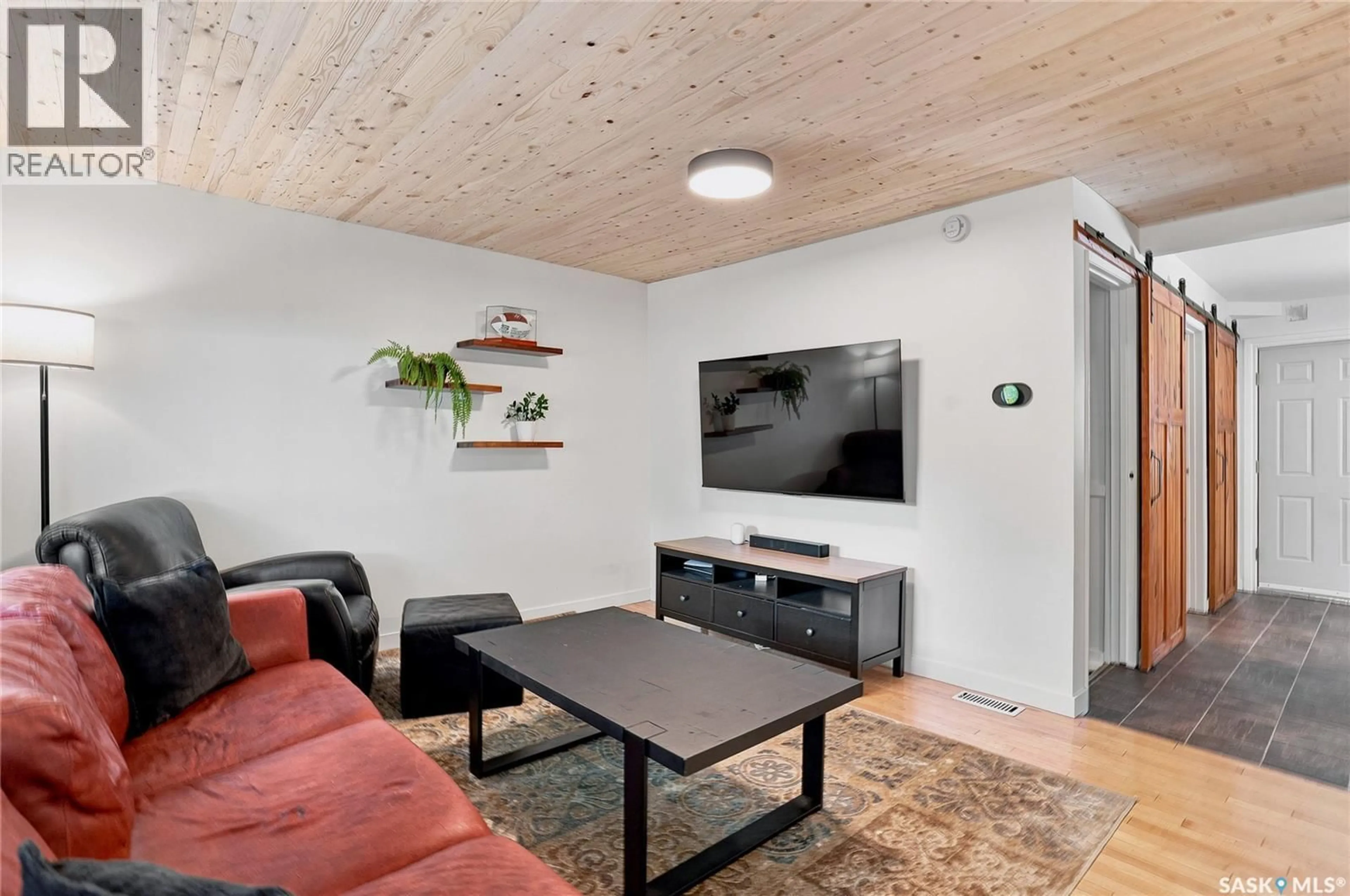 Living room with furniture, wood/laminate floor for 837 5TH STREET, Saskatoon Saskatchewan S7H1G8