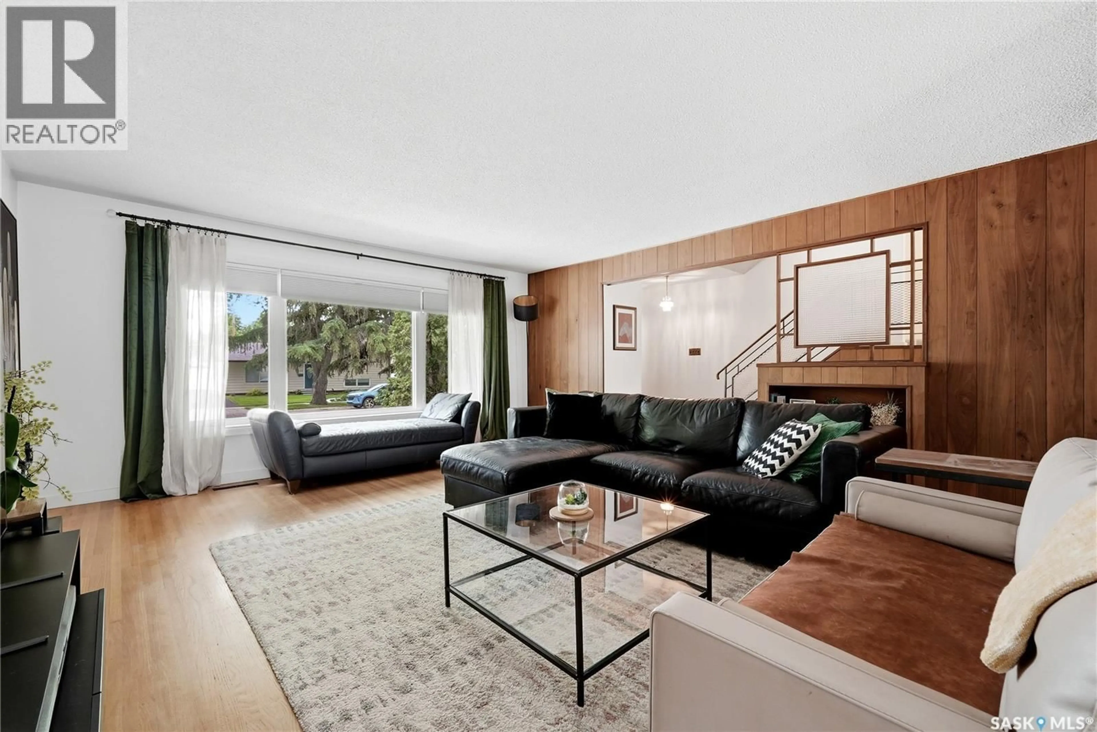 Living room with furniture, wood/laminate floor for 111 BELL STREET, Regina Saskatchewan S4S4C2