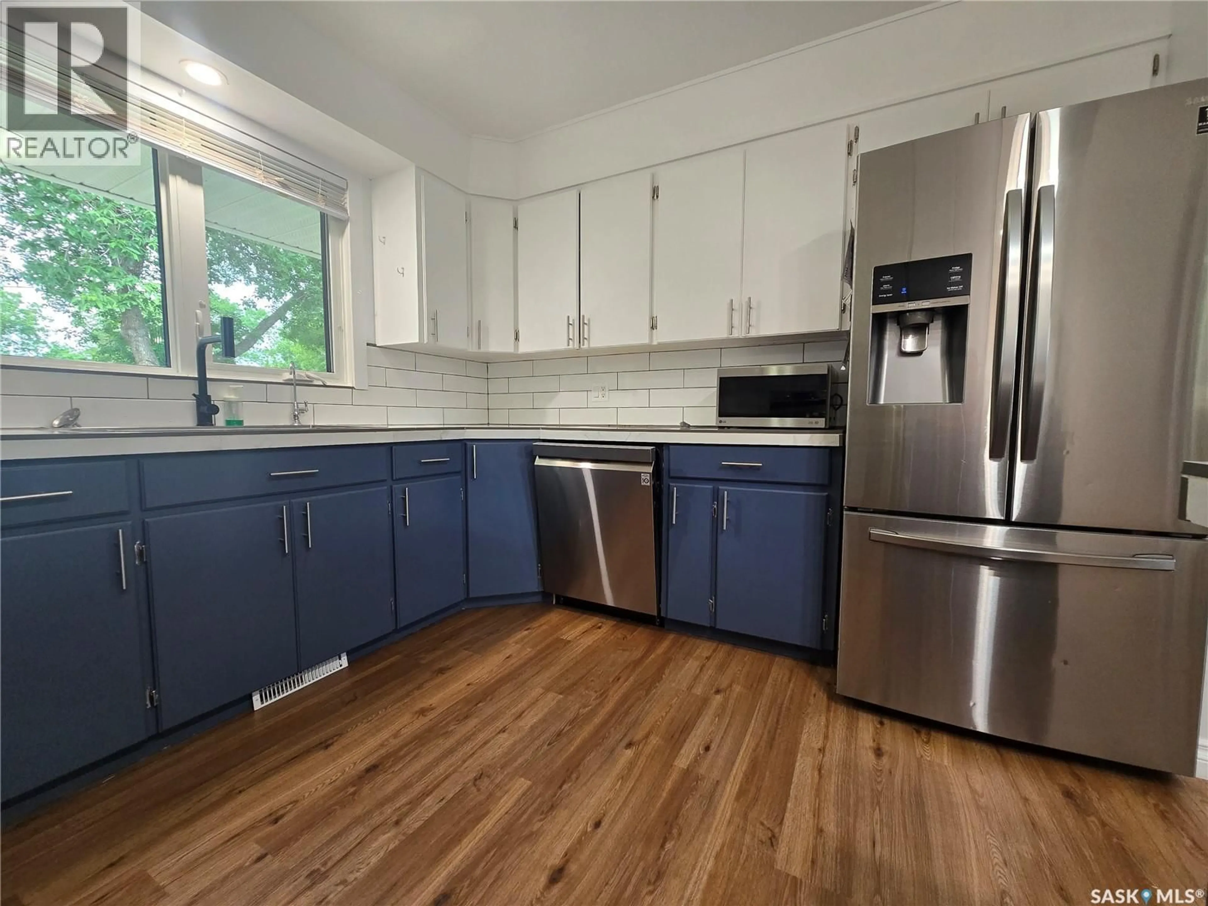 Open concept kitchen, wood/laminate floor for 98 13TH STREET, Weyburn Saskatchewan S4H1L1
