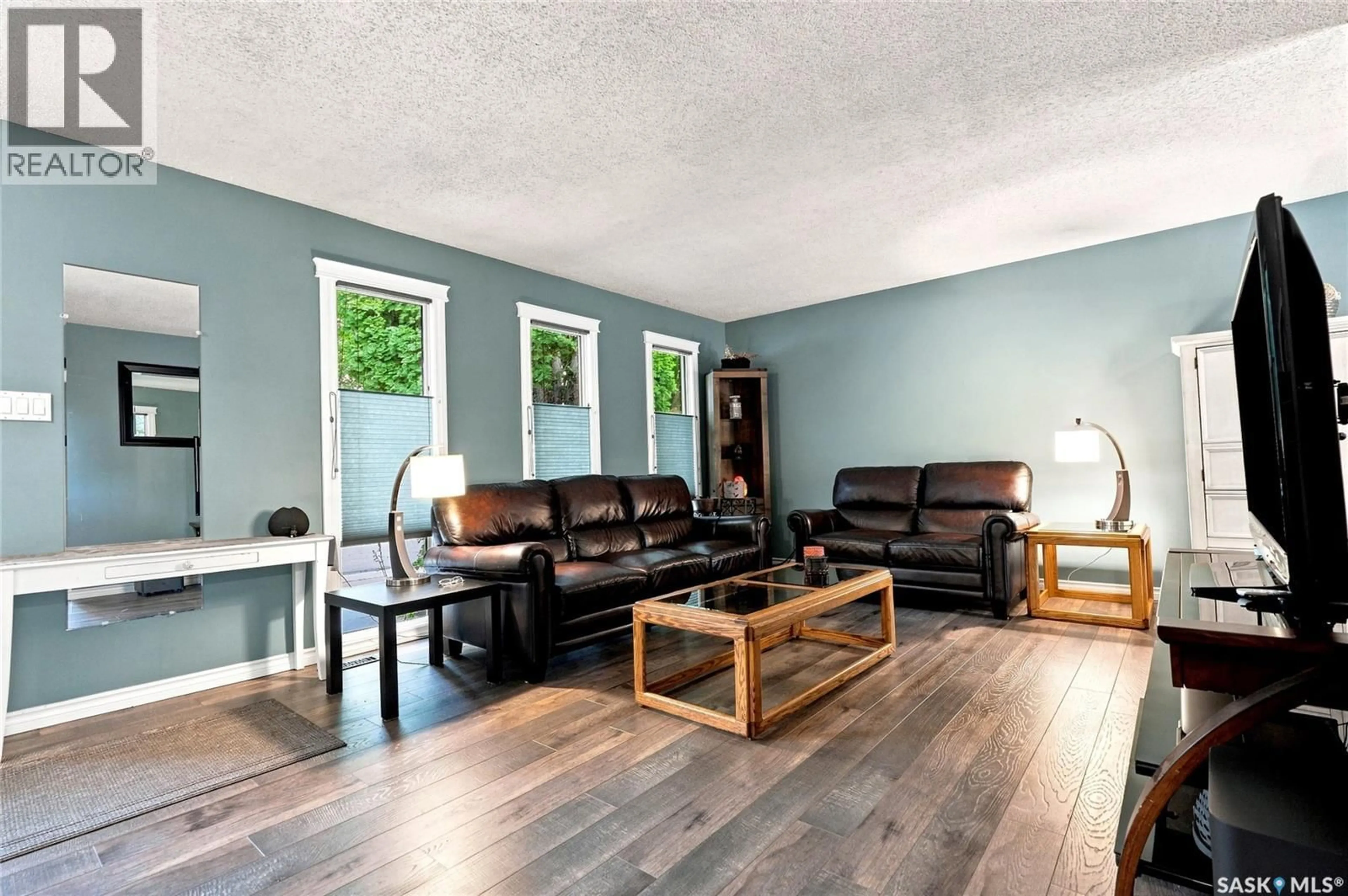 Living room with furniture, wood/laminate floor for 242 CANDLE CRESCENT, Saskatoon Saskatchewan S7K5A4