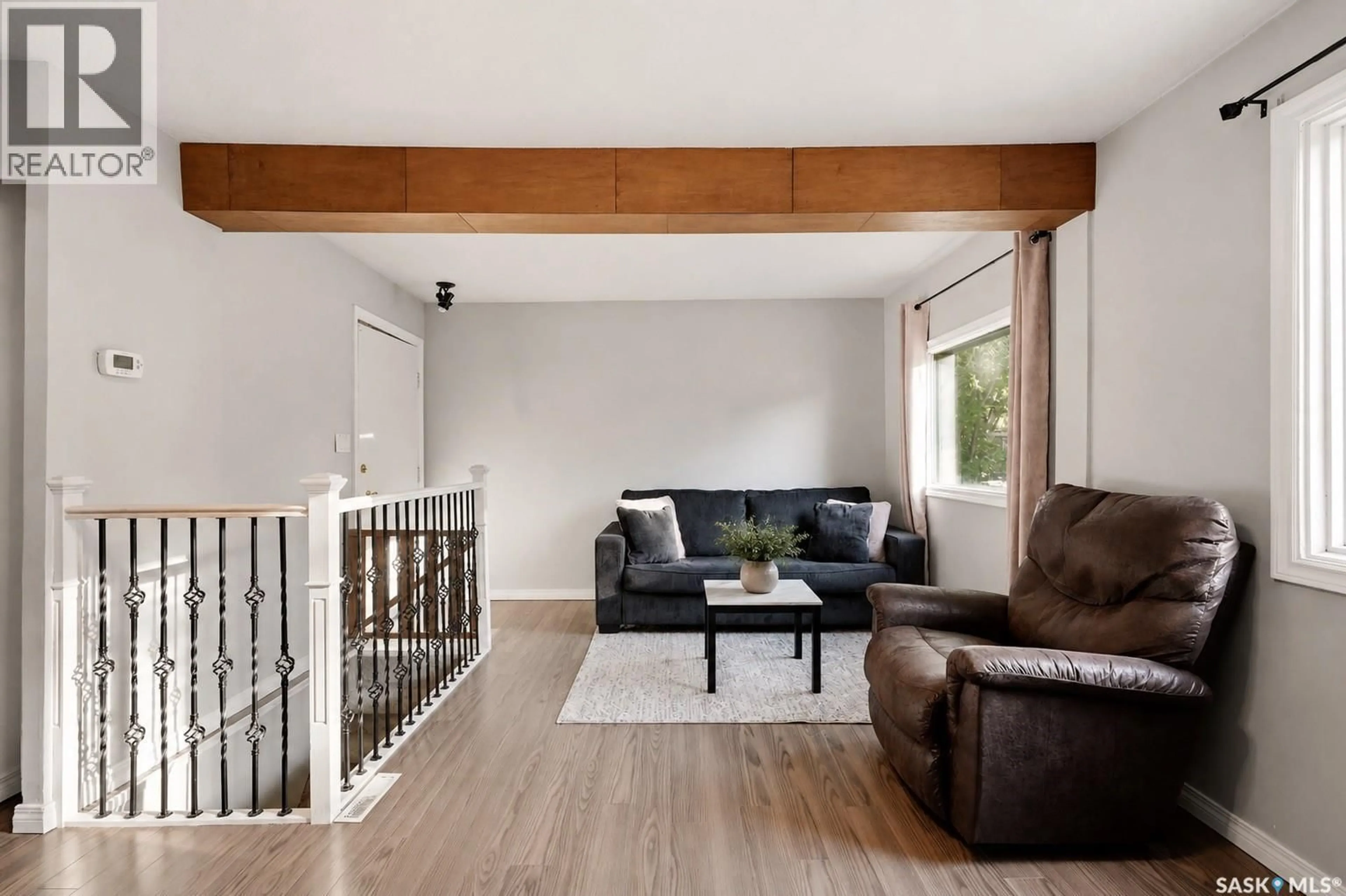 Living room with furniture, wood/laminate floor for 1728 2ND AVENUE, Saskatoon Saskatchewan S7K2G5