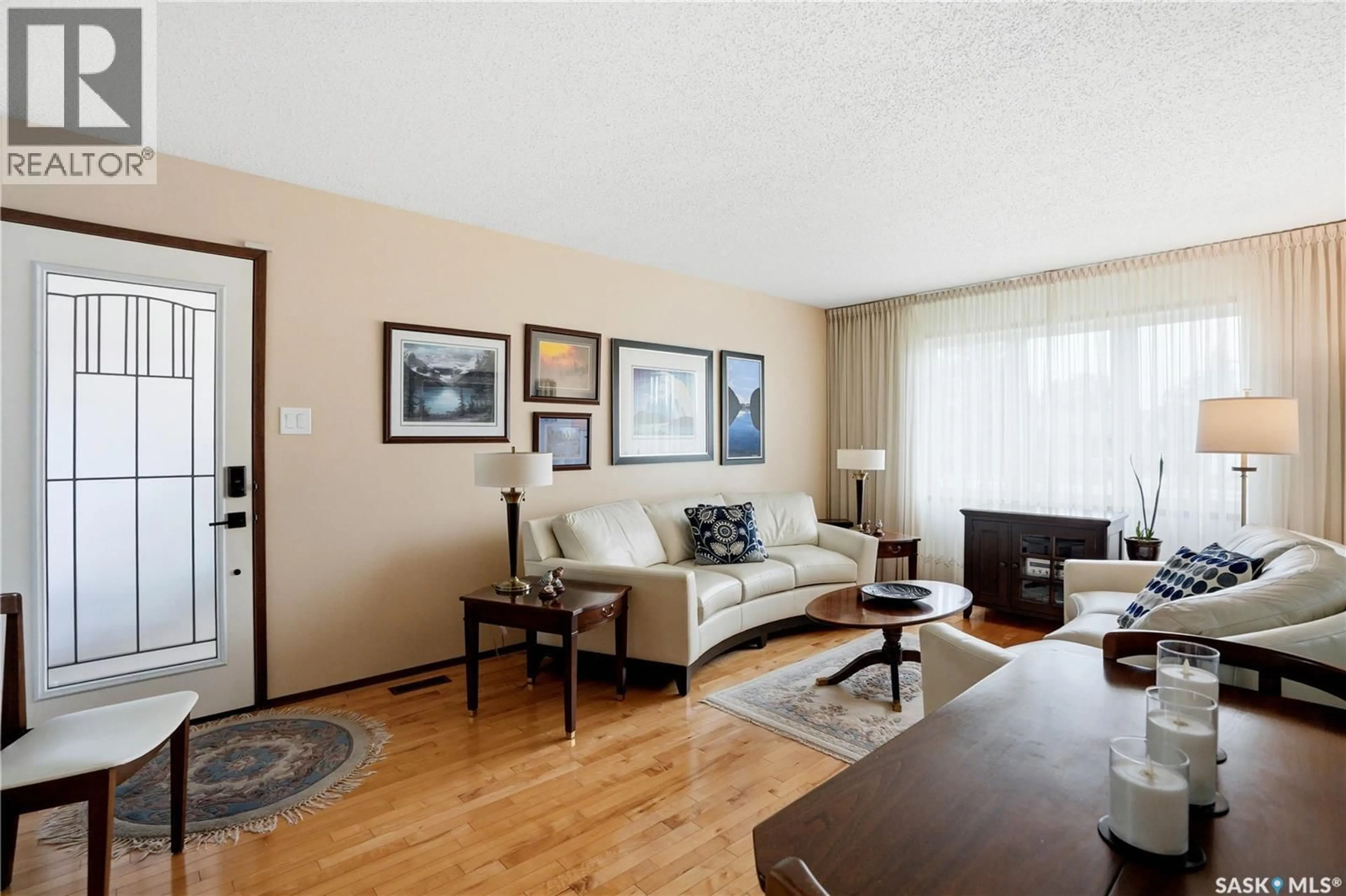 Living room with furniture, wood/laminate floor for 3801 DIEFENBAKER DRIVE, Saskatoon Saskatchewan S7L5C6