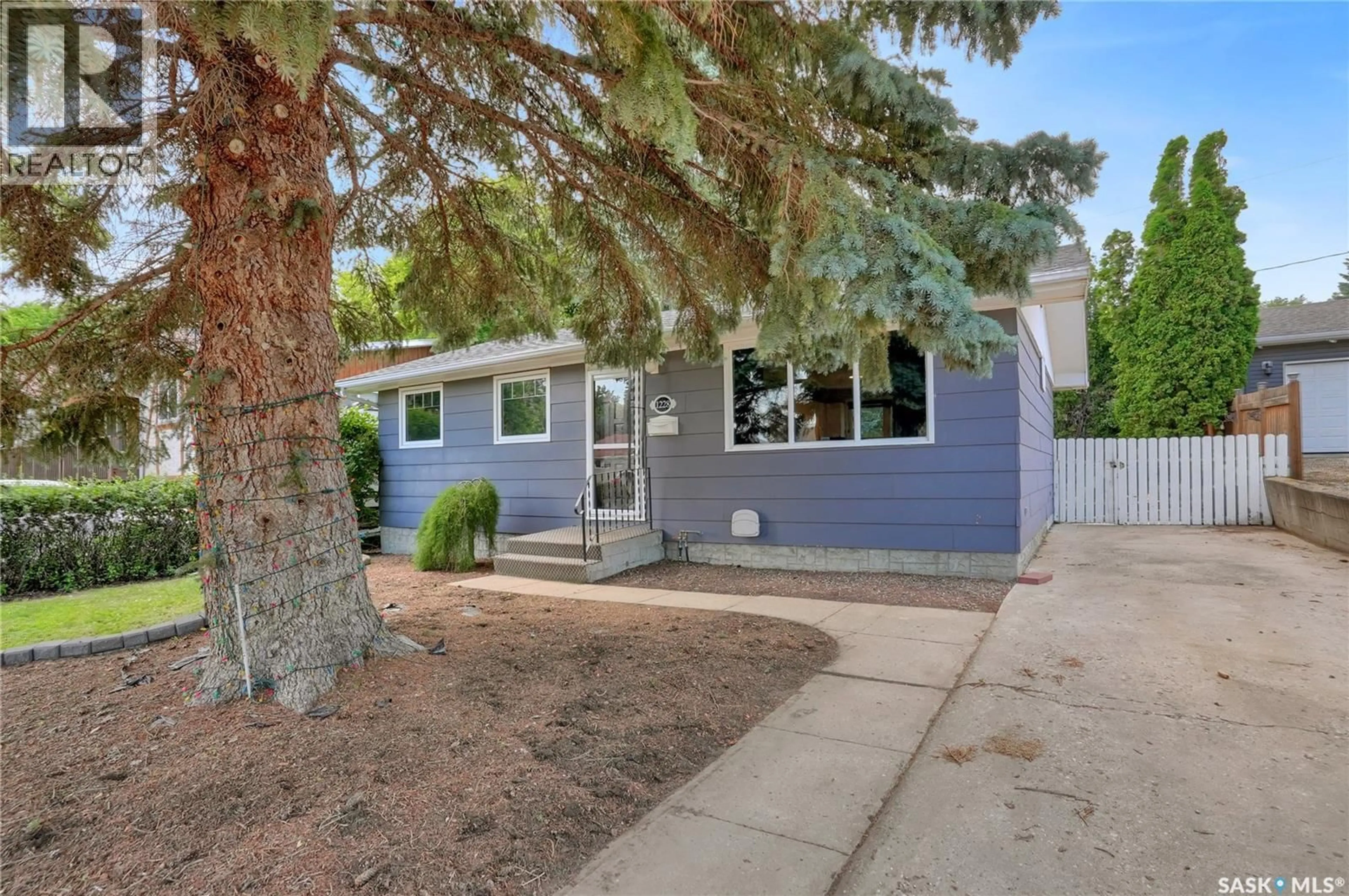 Home with vinyl exterior material, street for 1228 ATHABASCA STREET, Moose Jaw Saskatchewan S6H6C6