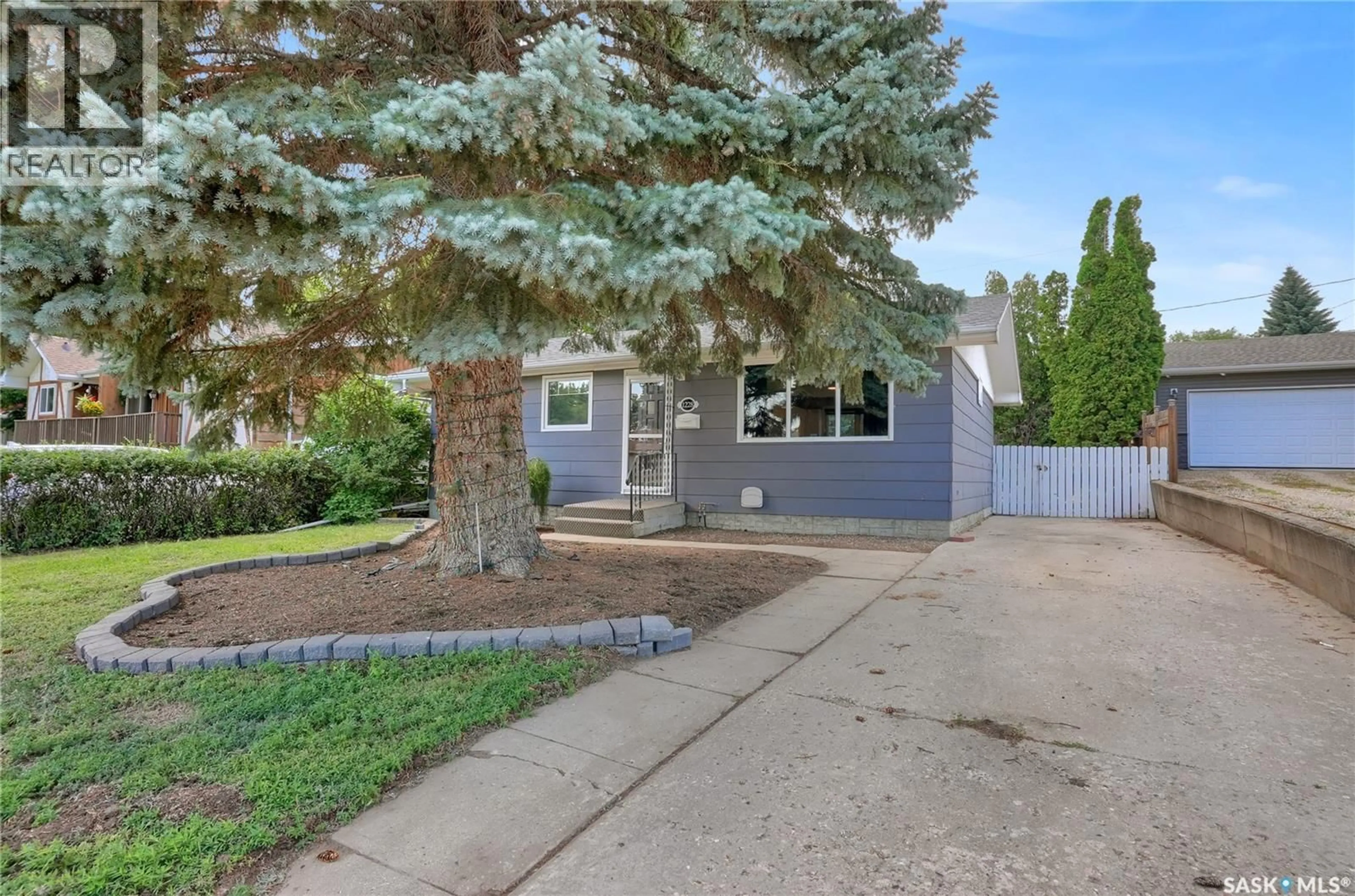 Home with vinyl exterior material, street for 1228 ATHABASCA STREET, Moose Jaw Saskatchewan S6H6C6